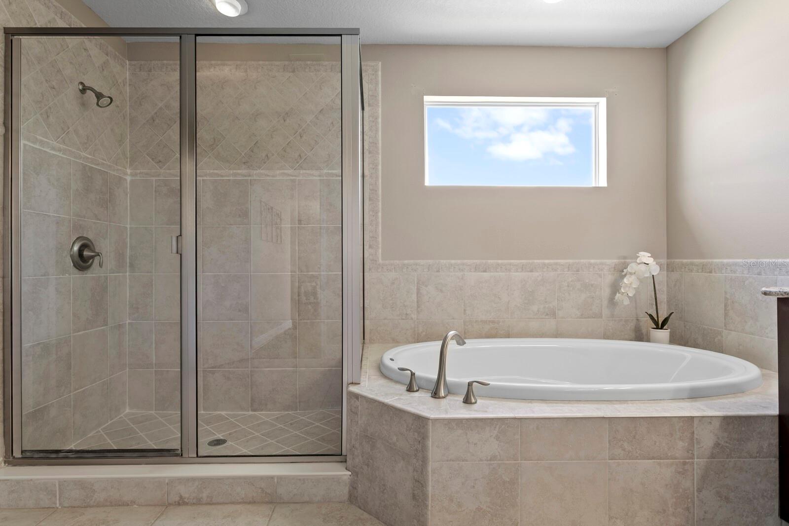 Jetted Jacuzzi tub and oversized walk-in shower