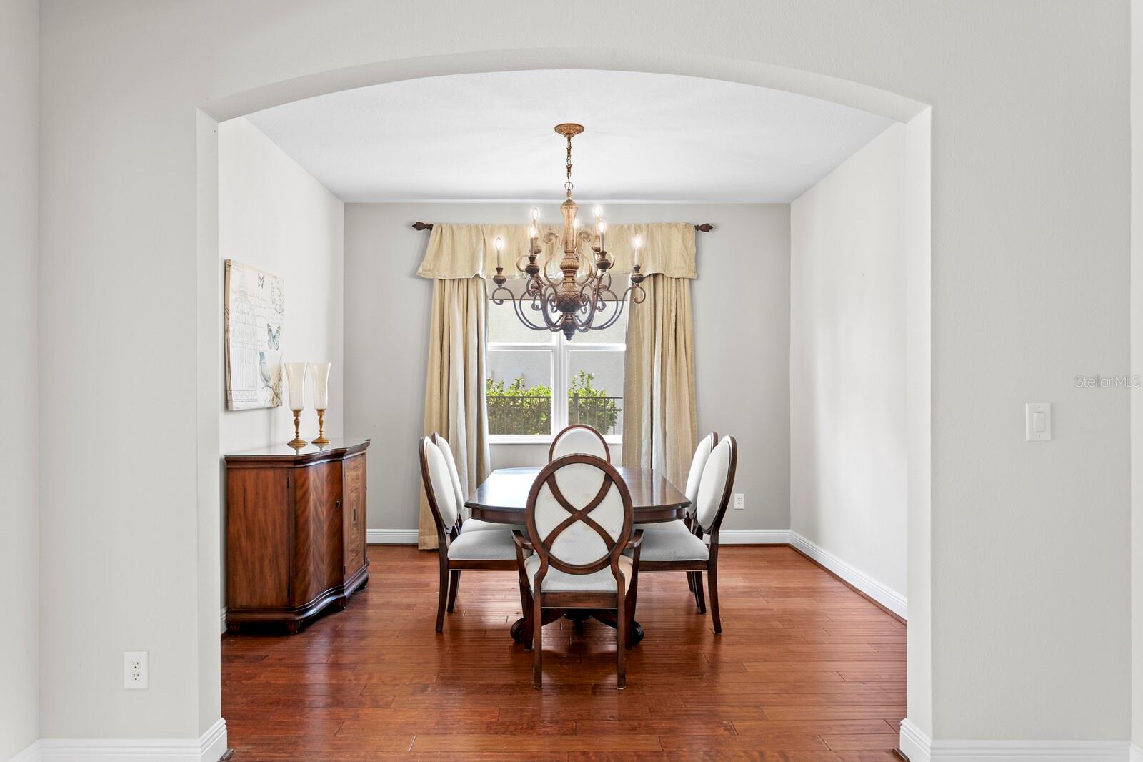 Graceful arches from the foyer into the formal dining room