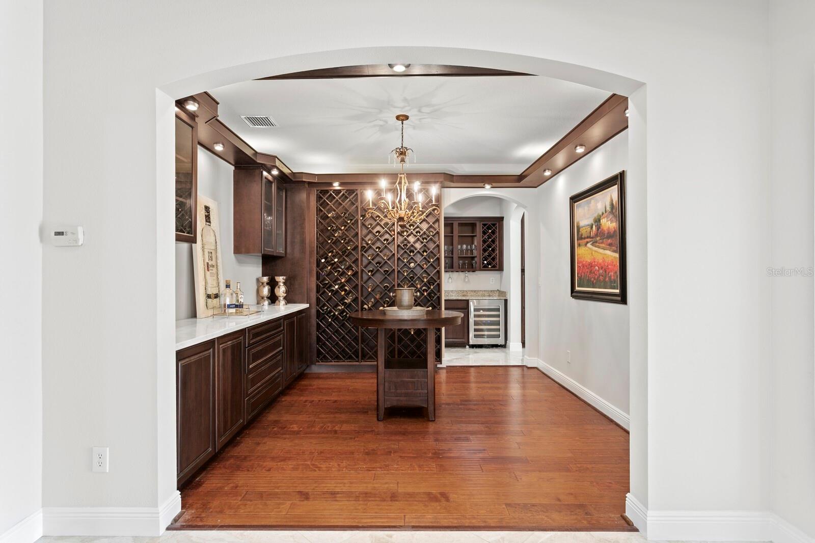Wthe wine room is across the foyer from the formal dining room