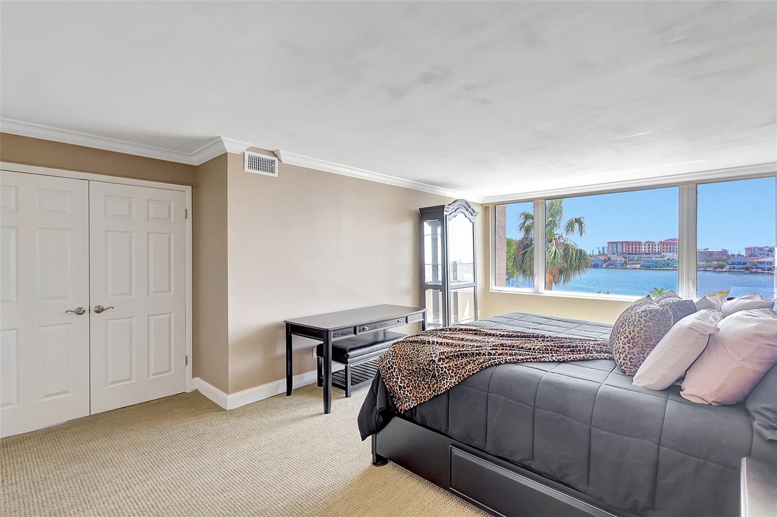 The primary bedroom has double doors to enter and exit your suite