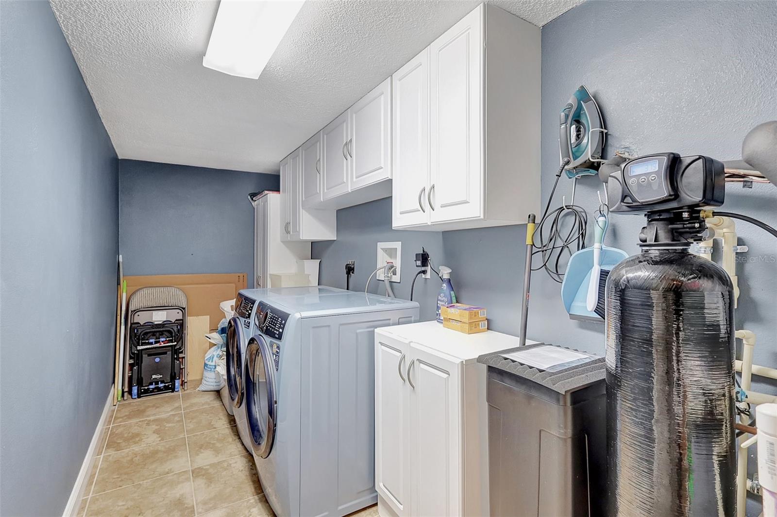 Laundry, with new washer/dryer, stoarge cabinets and water softener system
