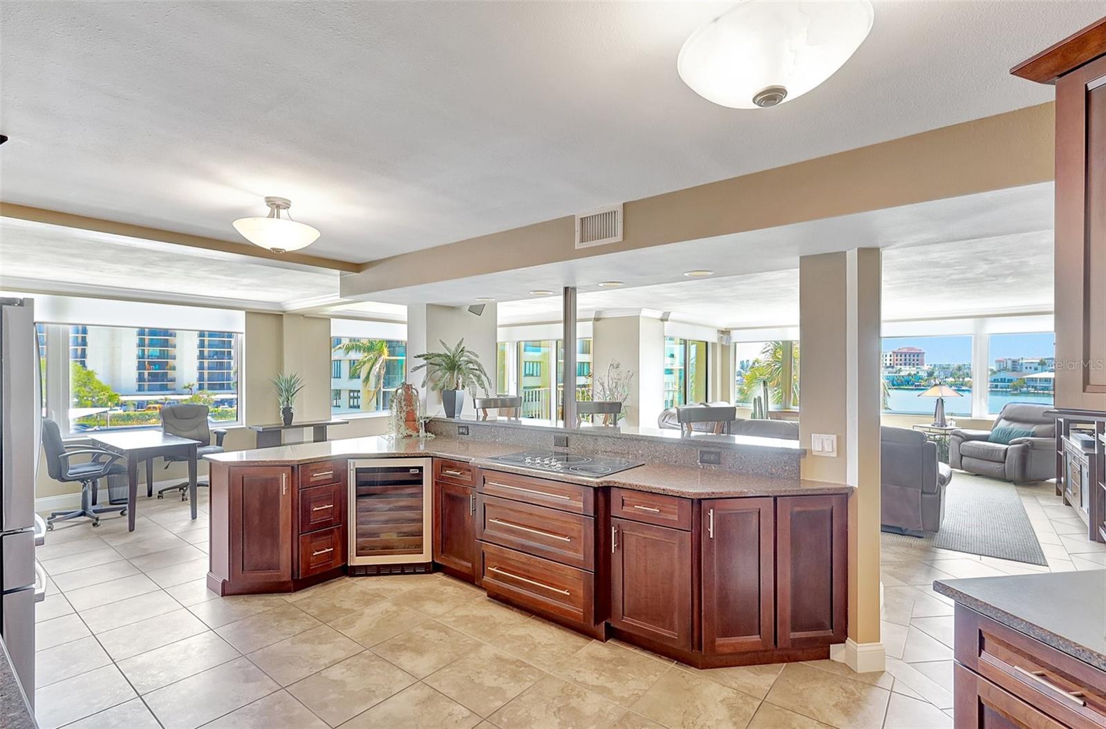 Open kitchen with a wine fridge that leads to the dining area and living space