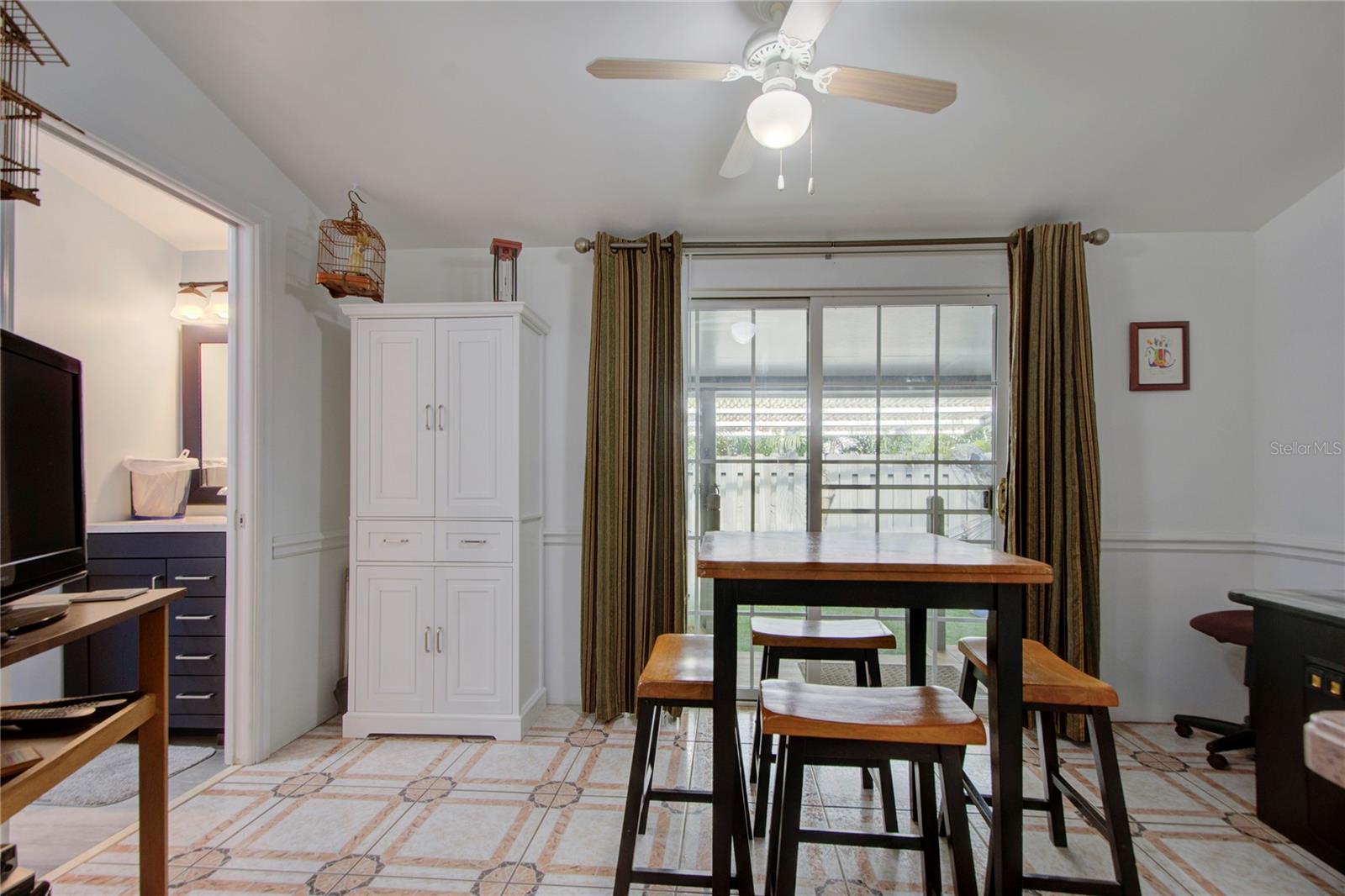 looking from master bedroom entrance to dining room and side porch area through sliding doors