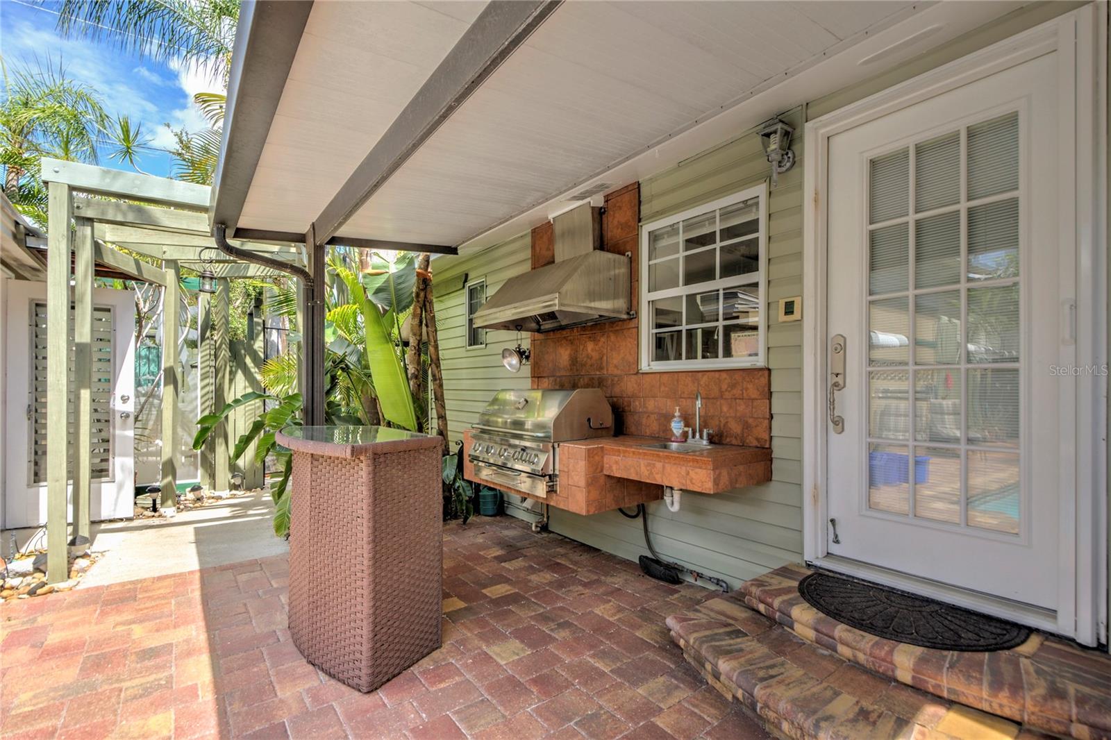 back entrance and barbecue area w/ sink