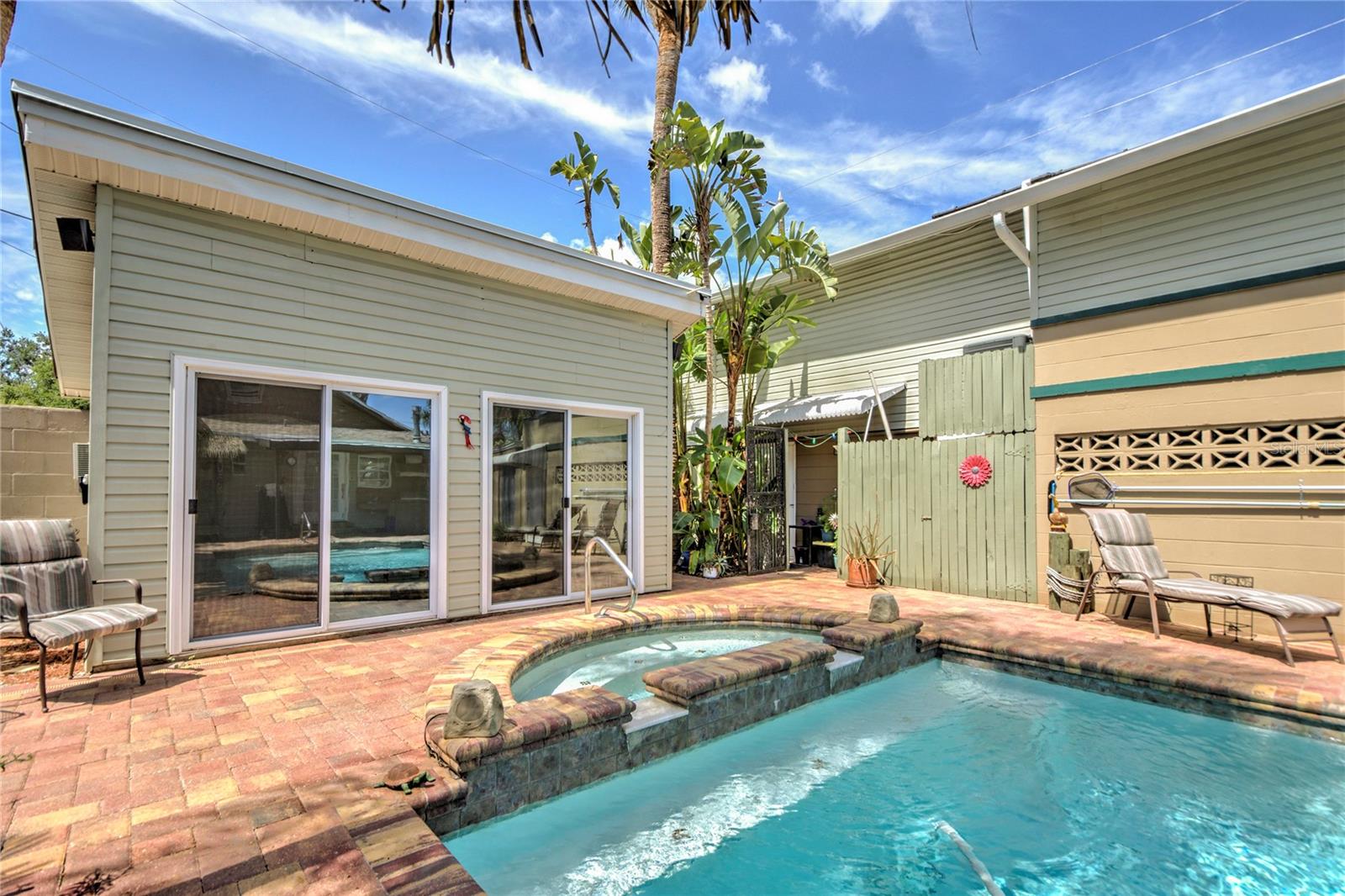 pool, jacuzzi, recreation cave and downstairs apartment off to right, entrance under awning