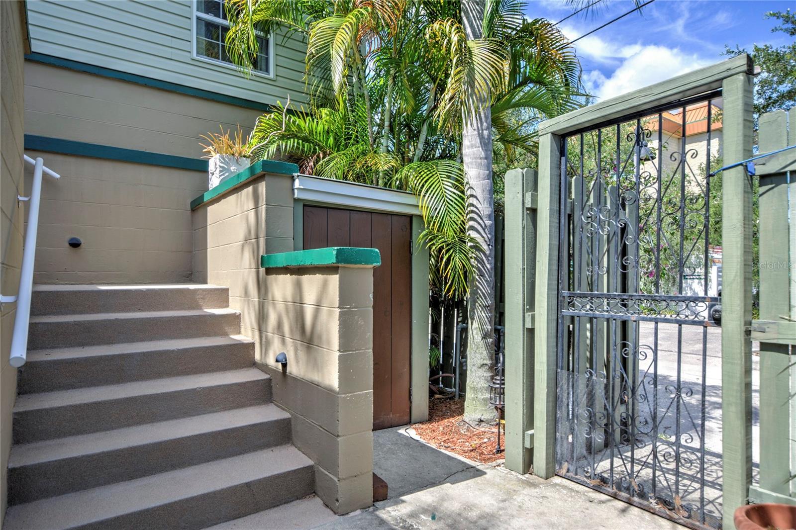 side gate to alley and stairs to upper apartment