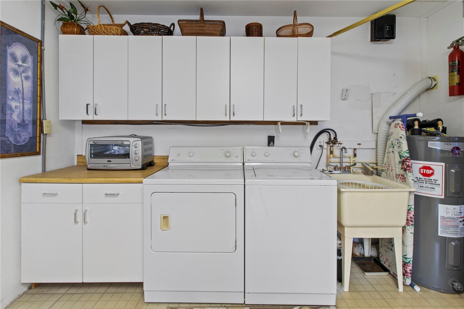 Spacious laundry room with wash basin.