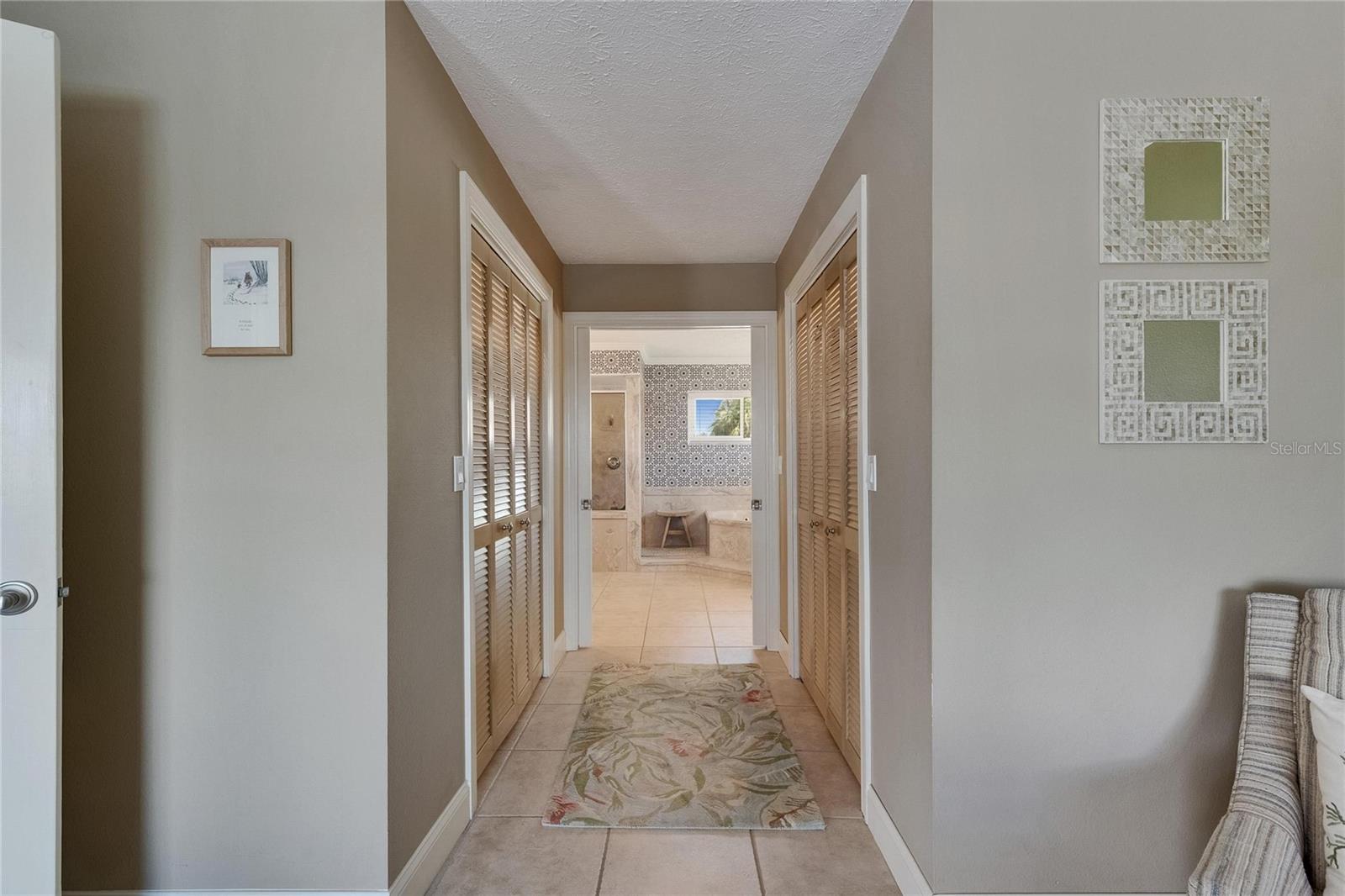 His and Her Closets - Pocket Door Separating the Primary Bedroom and the Master Bath