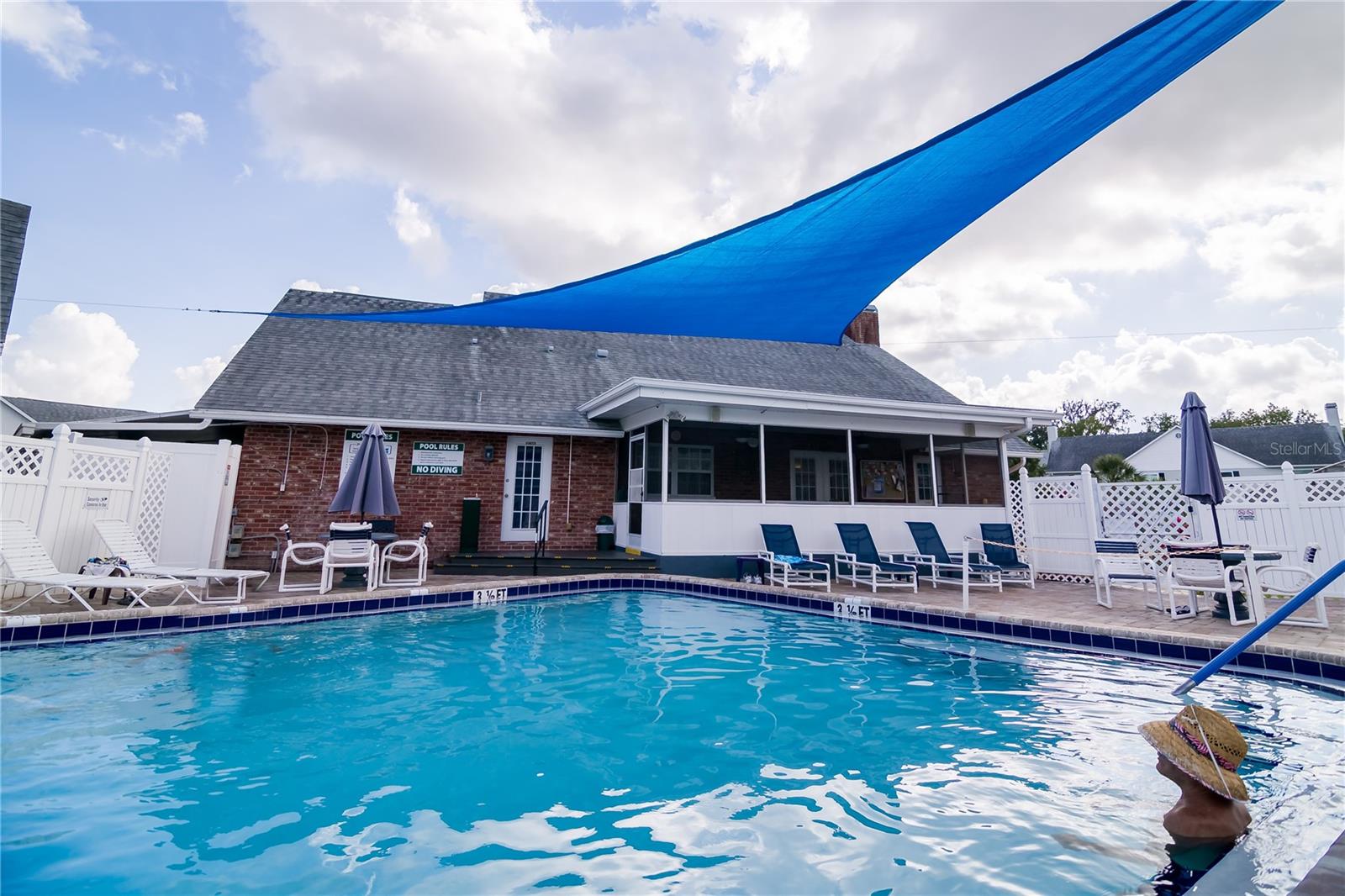 Clubhouse screen porch and lots of chairs. Outdoor shower as well