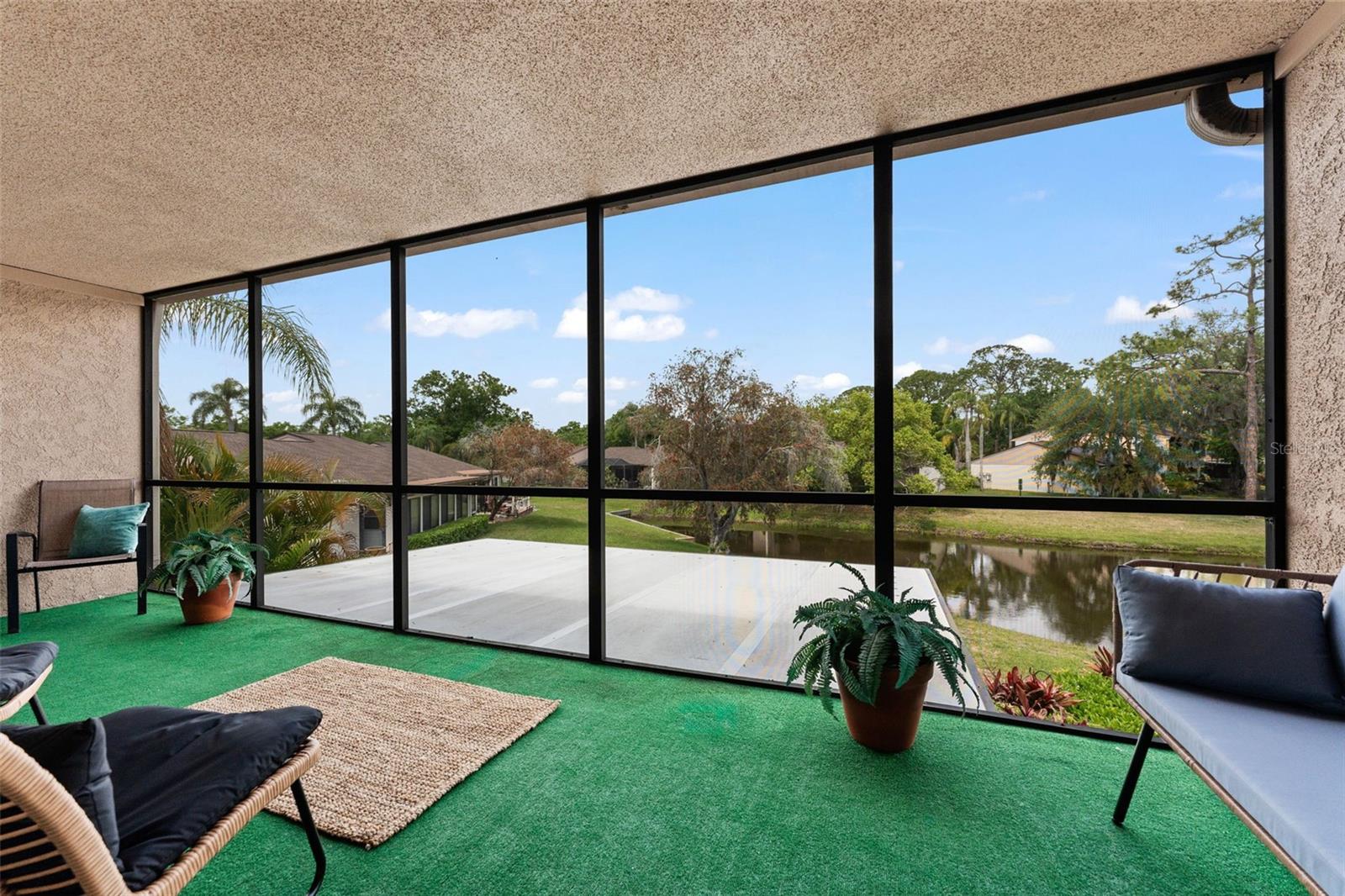 Second floor screened lanai with pond and nature views