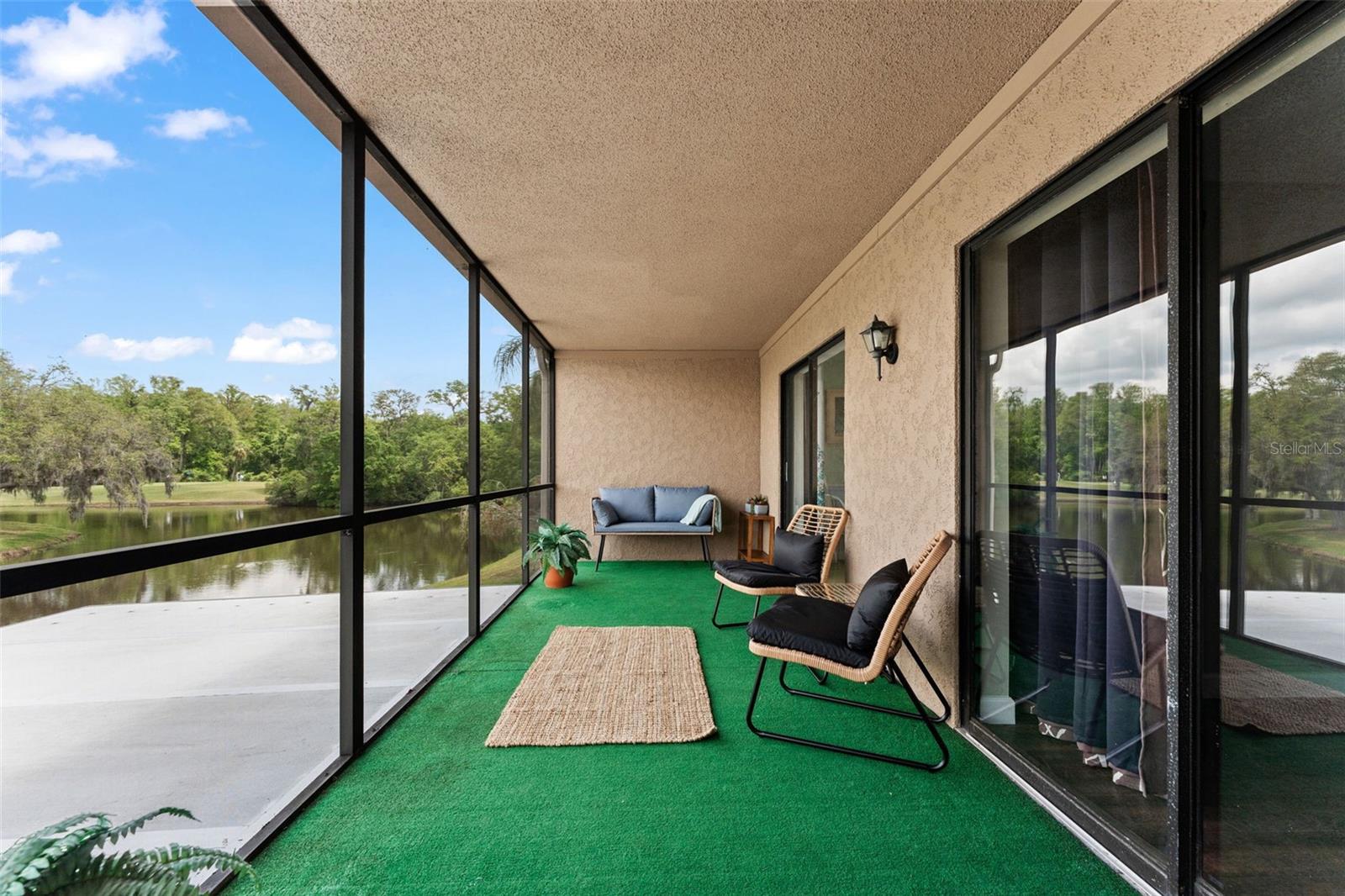 Second floor screened lanai with pond and