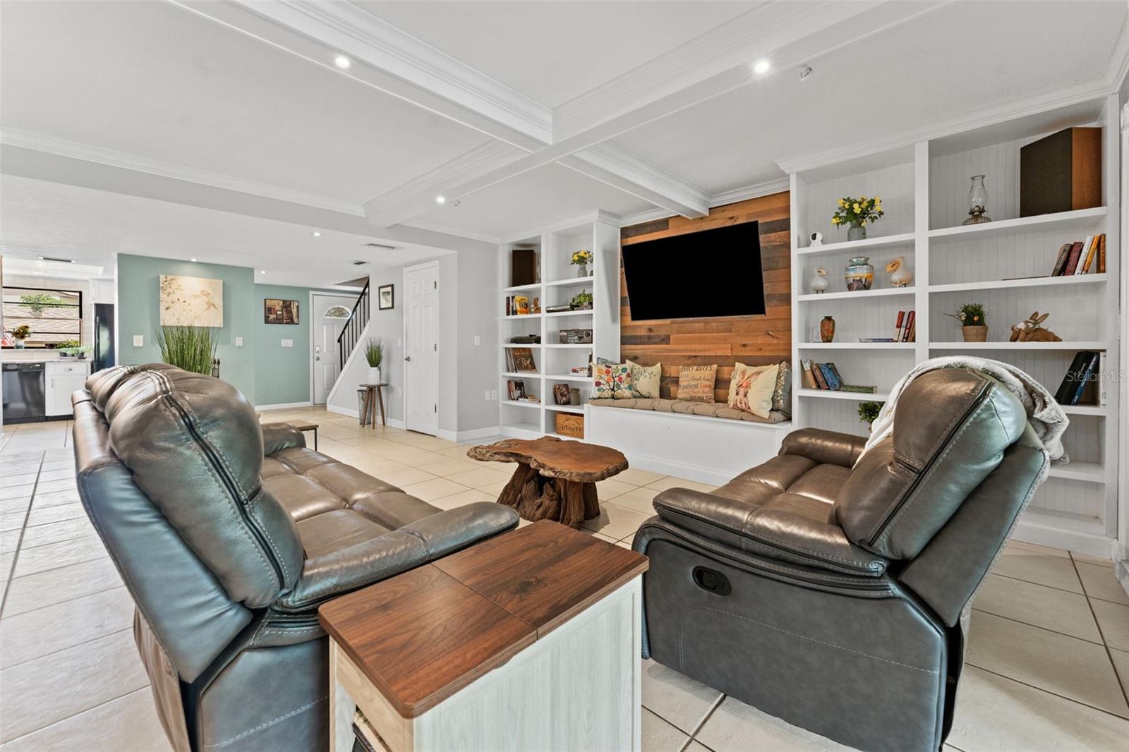 Open Concept living area with beautiful wood paneling and builtins