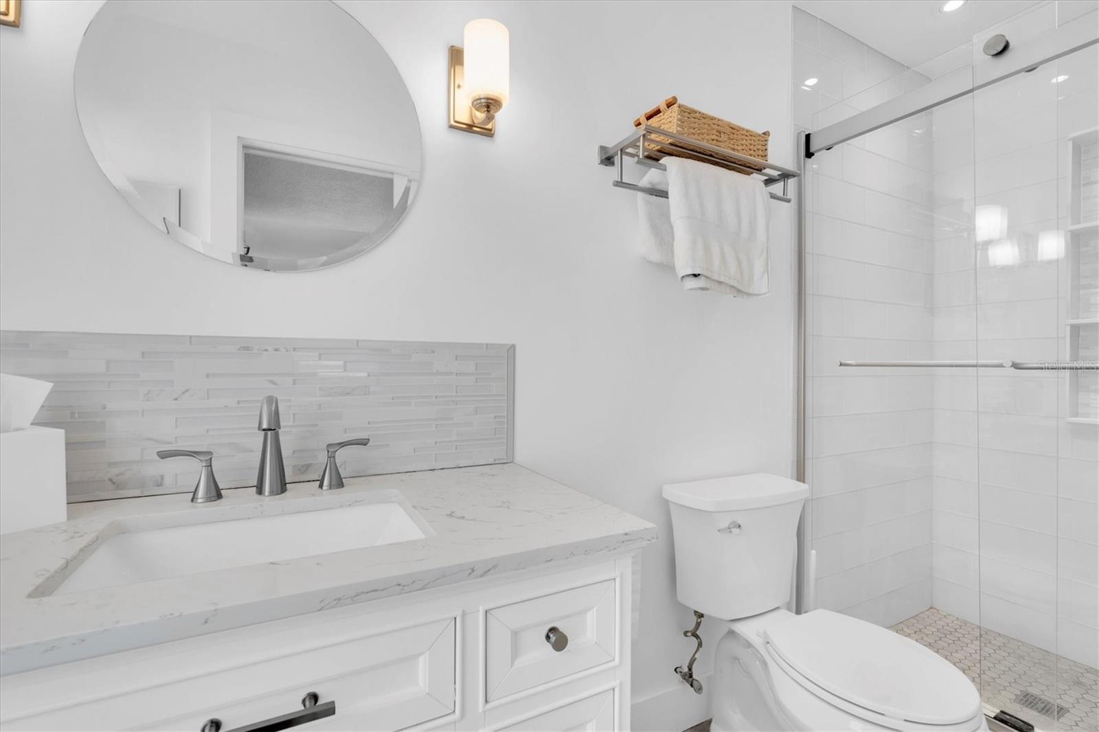The updated en suite is bright and white.  It's ready for your color palette!