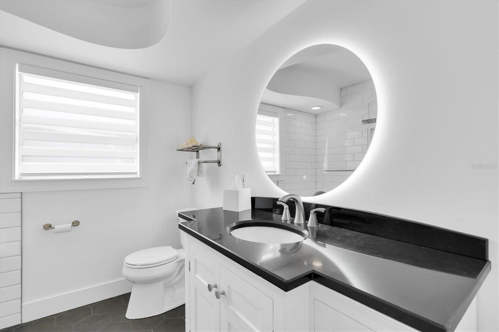 Main bath is also fully renovated and tucked in the hall between the two bedrooms.  There is also a huge closet outside of the bath for all your storage needs.