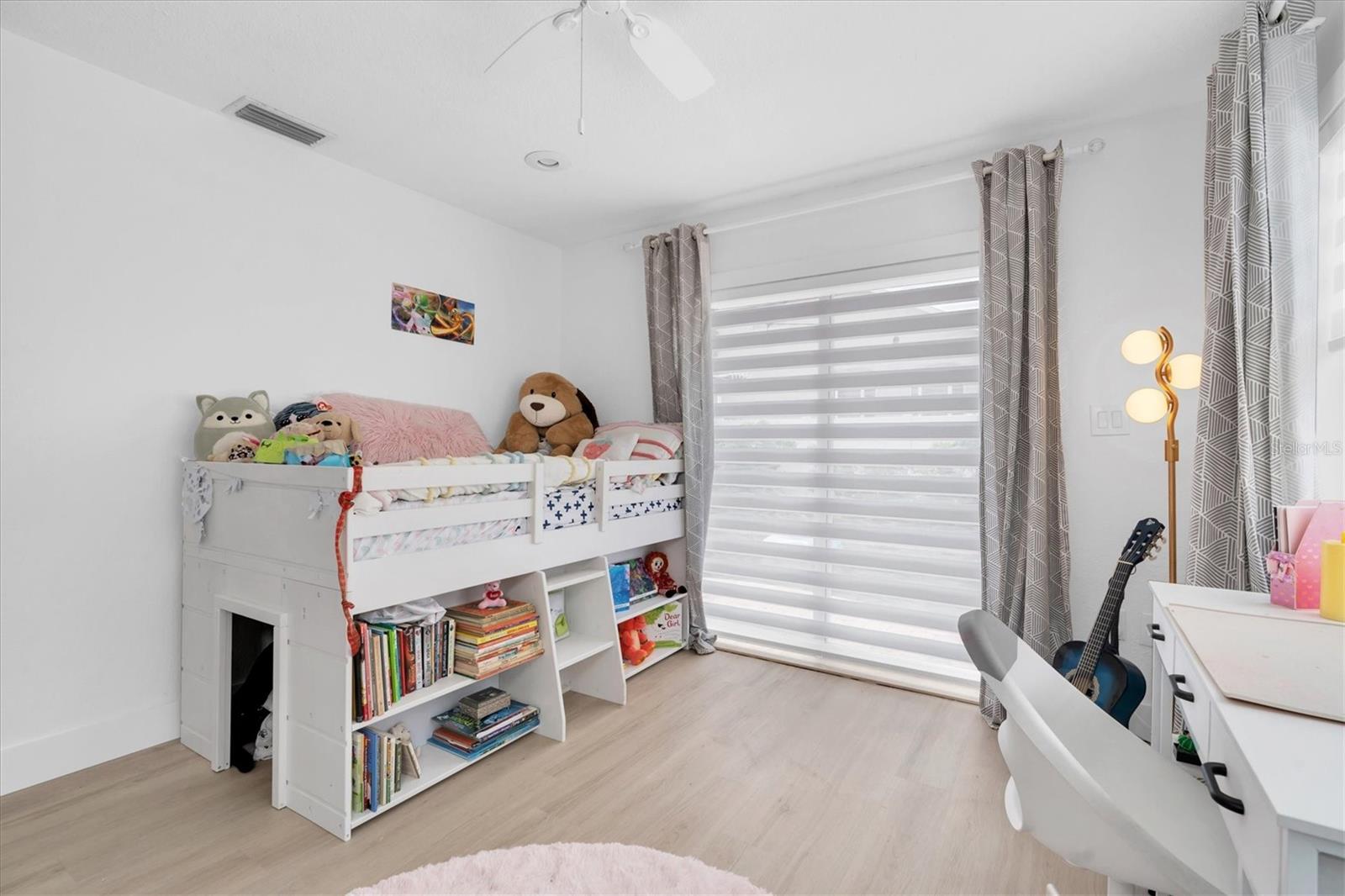 The secondary back bedroom overlooks the pool.