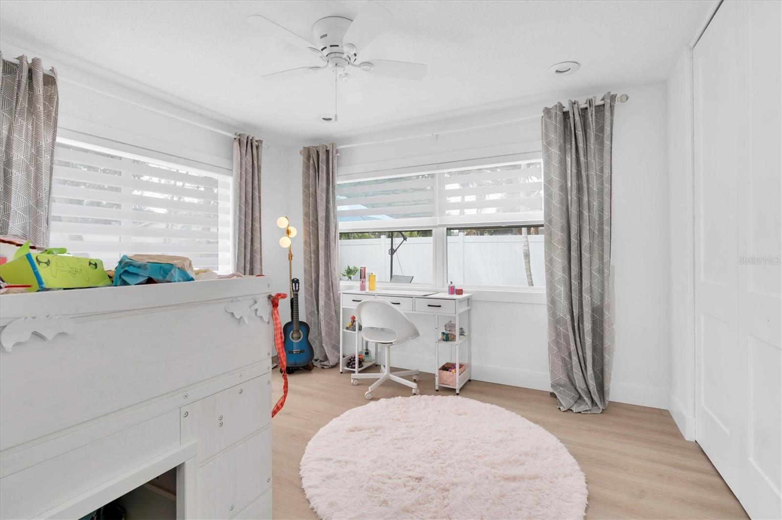 The closet in this room is huge and is organized with a closet system by Closetivity.