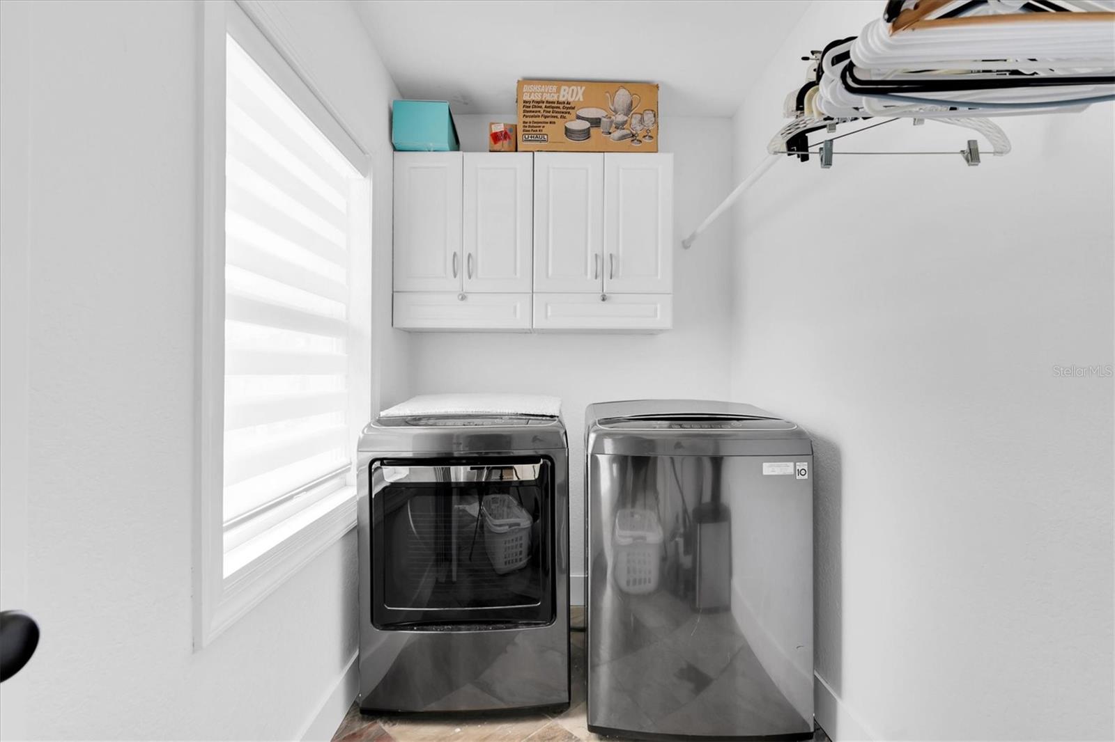 Inside laundry room with a window!!!  No more sweating in the garage or doing laundry in a dark, dingy room.  This laundry room offers lots of storage, too.