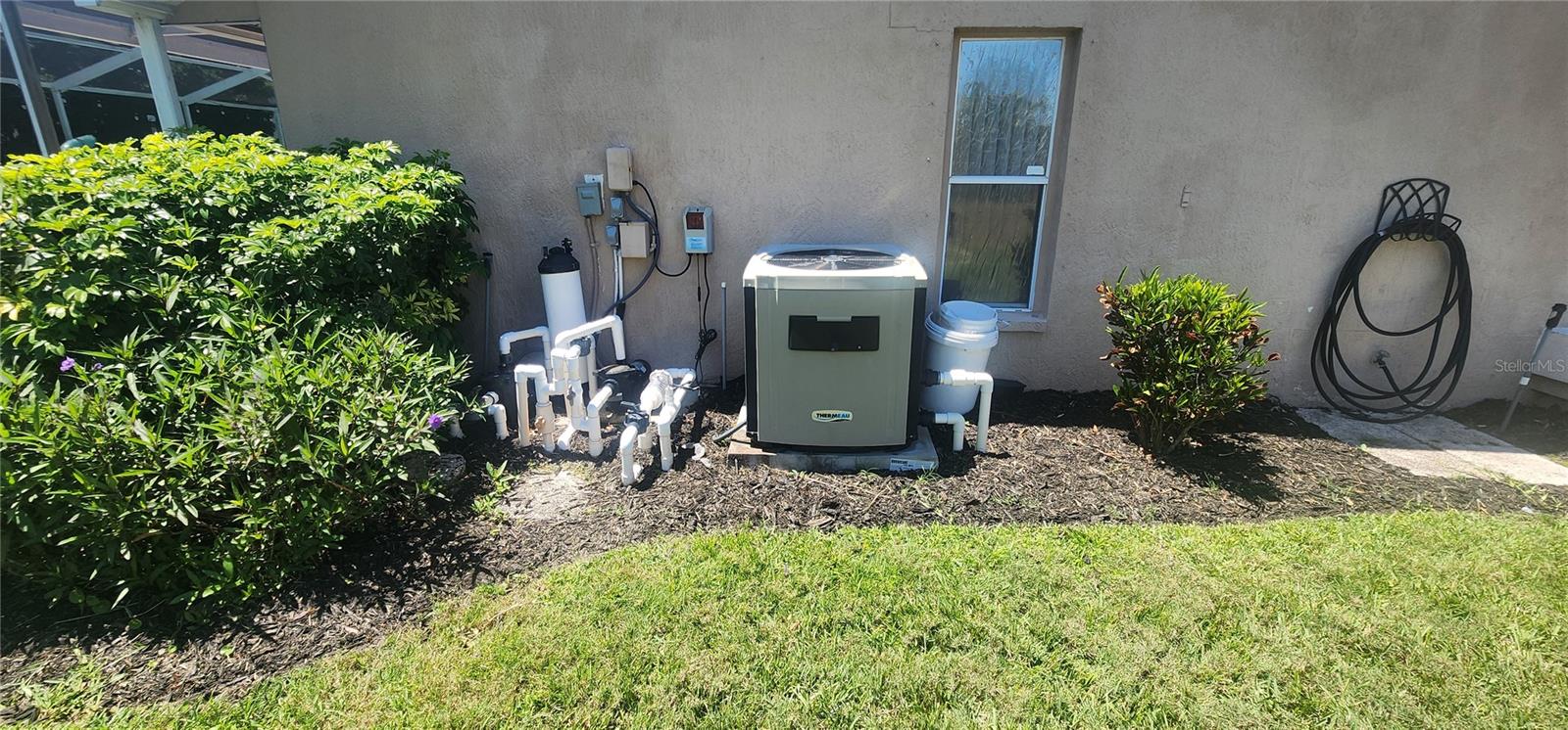 Side of home with Pool Heater/Pool Equipment