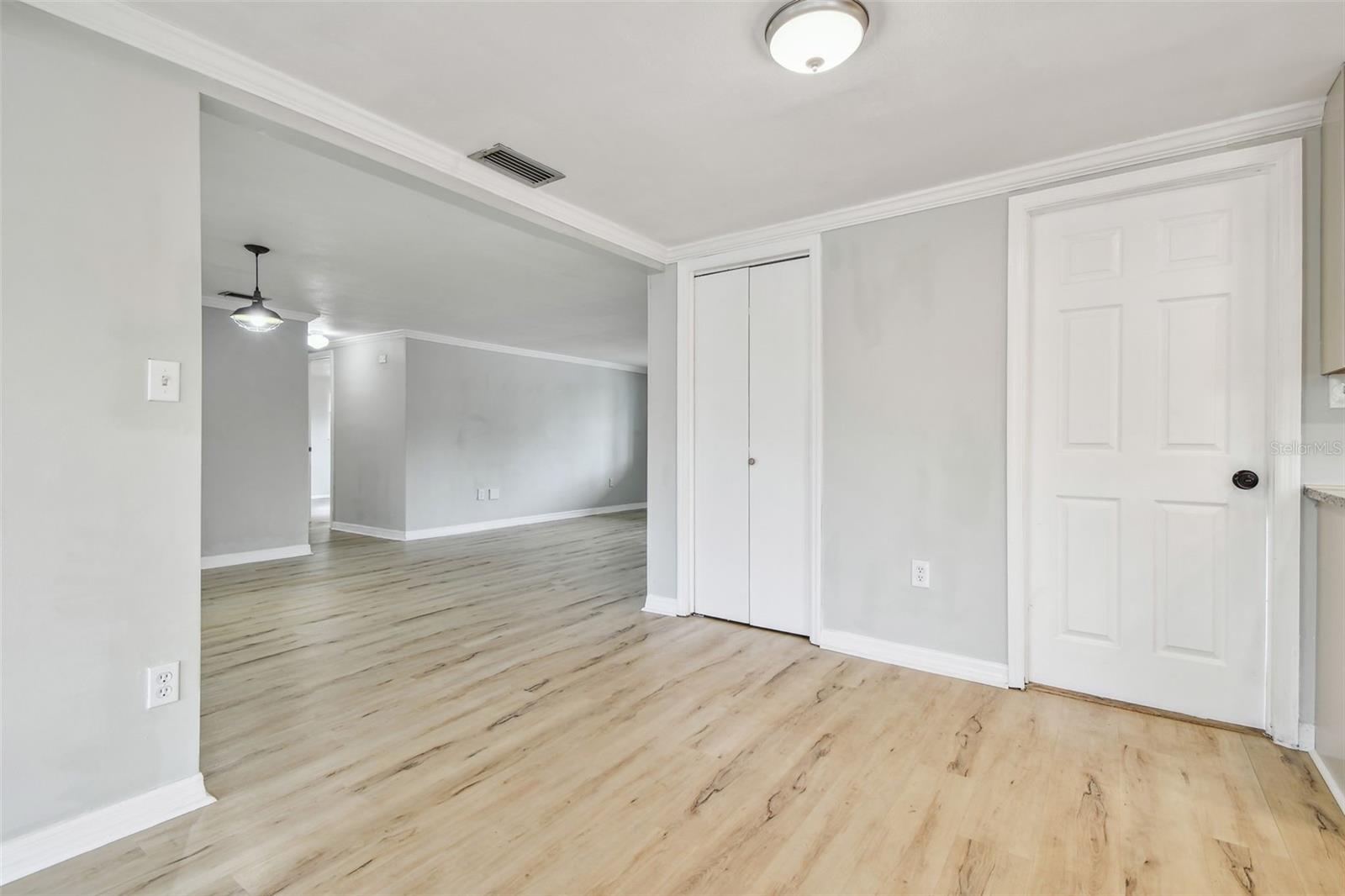 Looking from bonus room to kitchen, pantry closet and garage door
