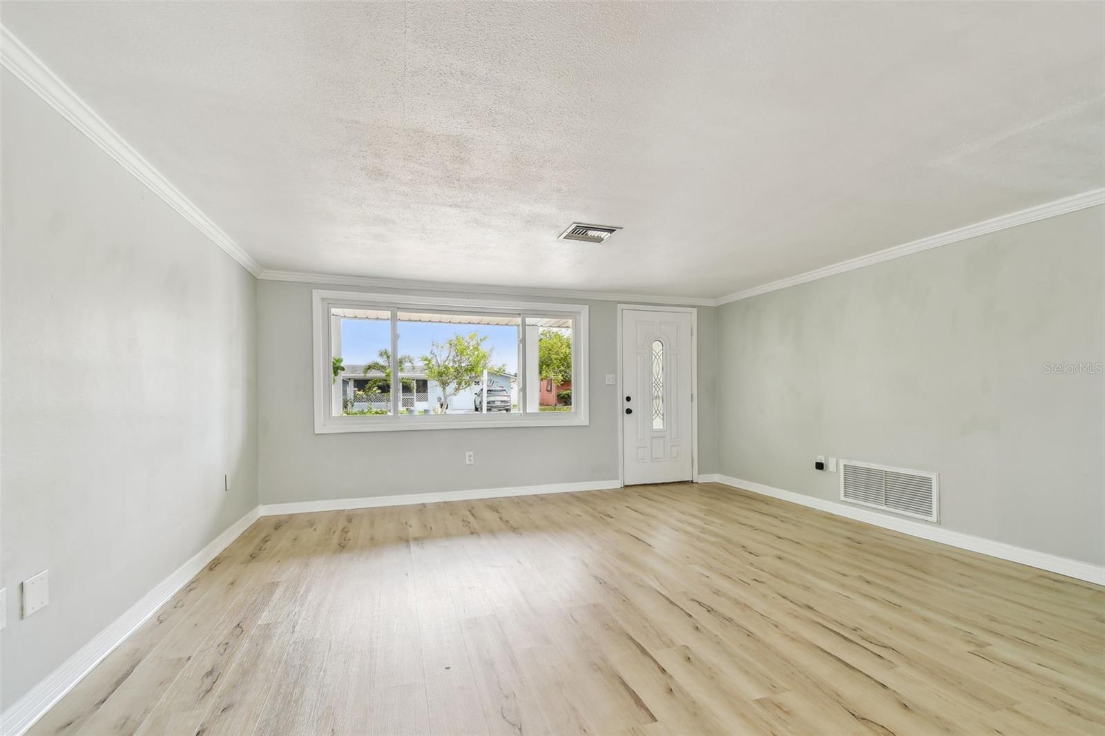 Living/Dining combo looking to front of home