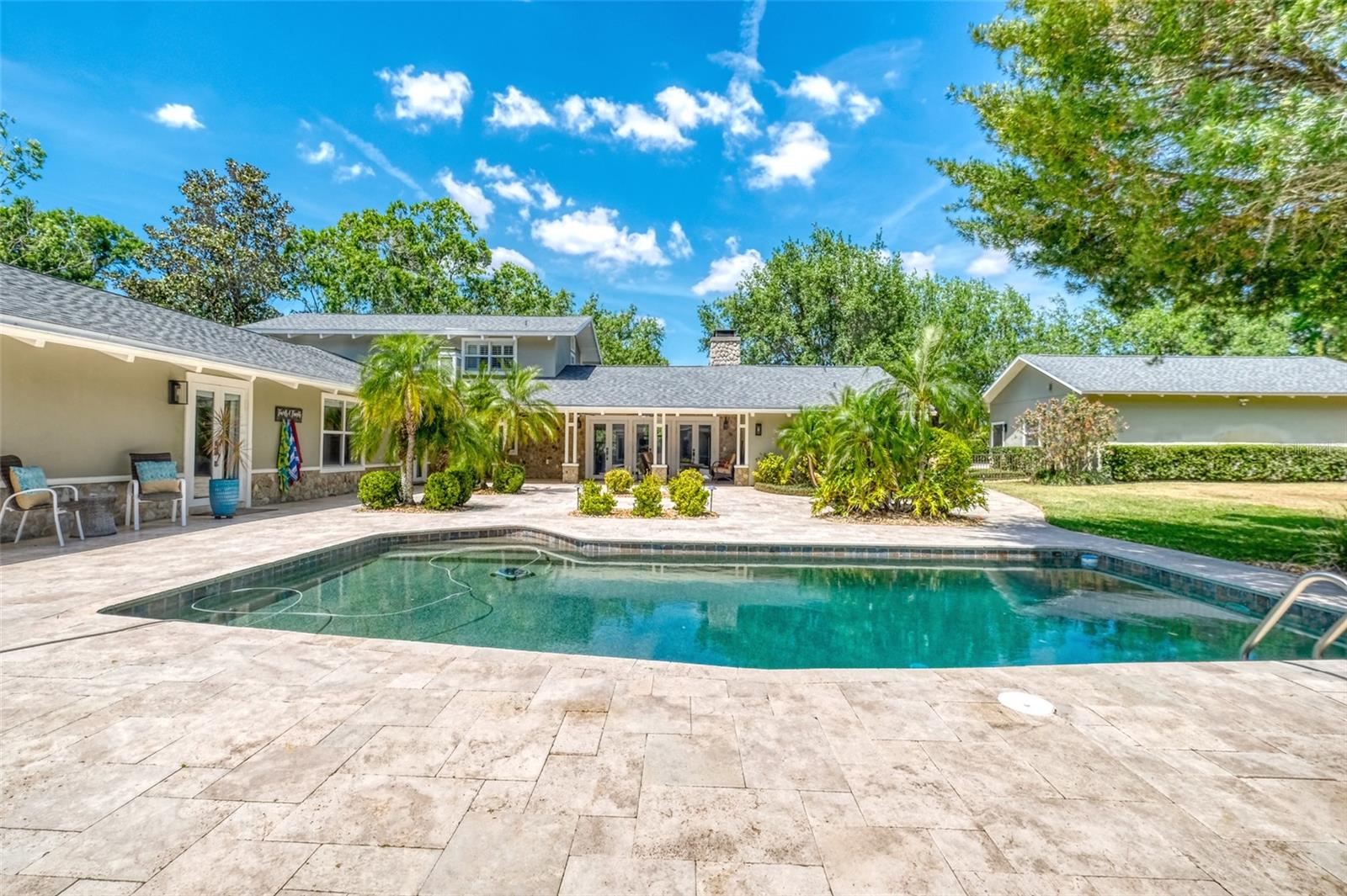 Travertine pavers and beautifully landscaped