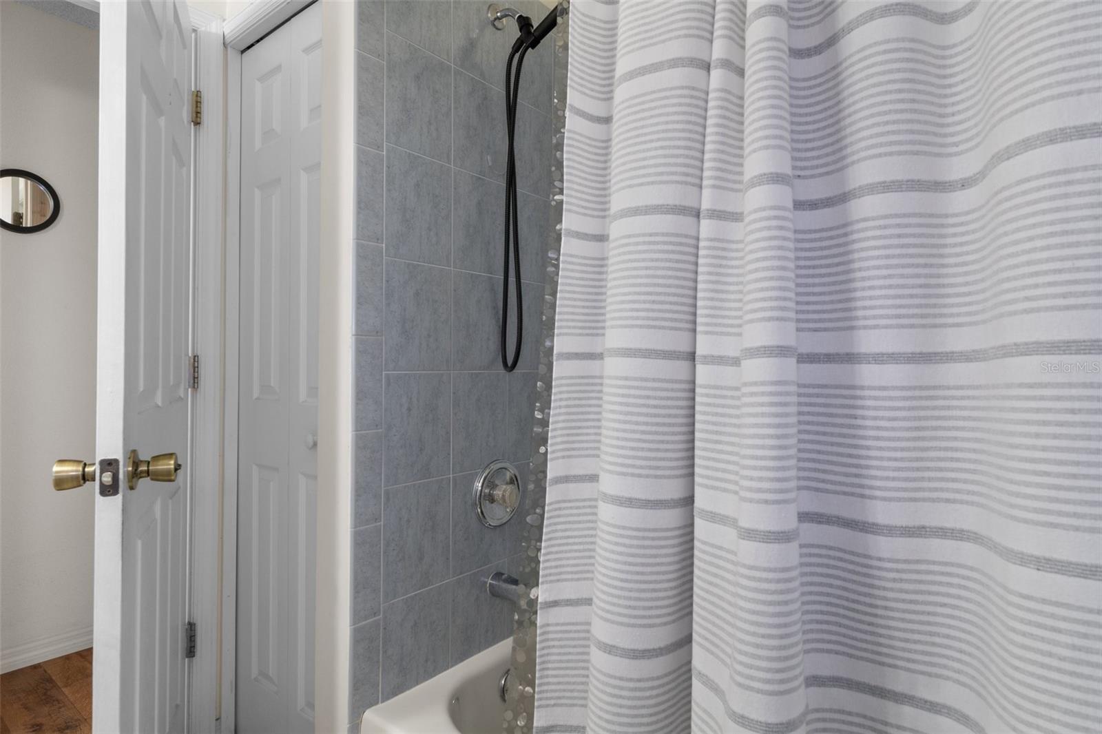The guest bathroom has a tub/shower combo