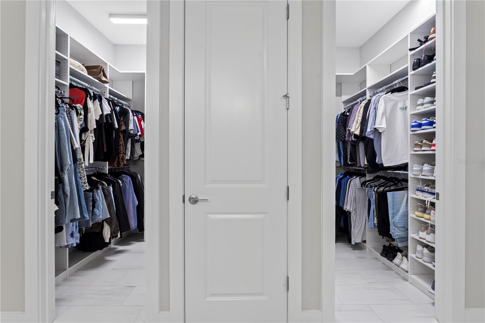 Dual custom walk-in closets for ultimate organization!
