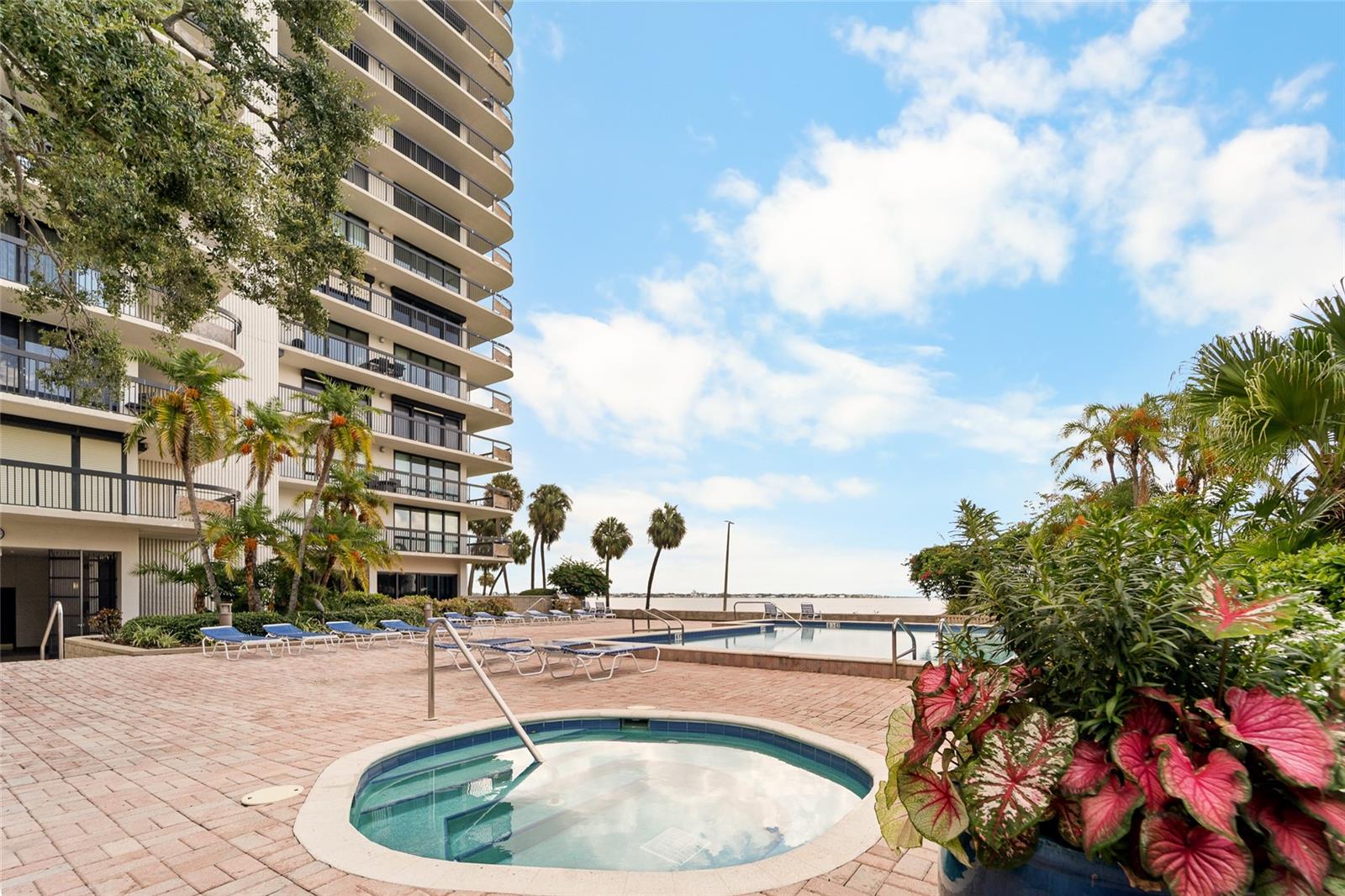 Pool and spa with view of Bay