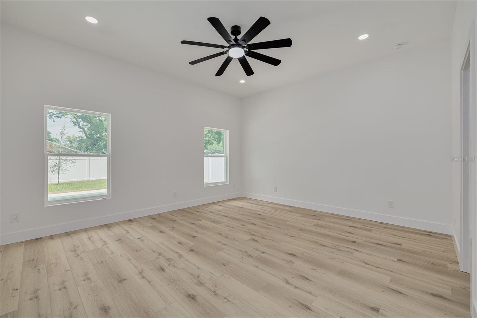 Primary bedroom, windows to the back yard