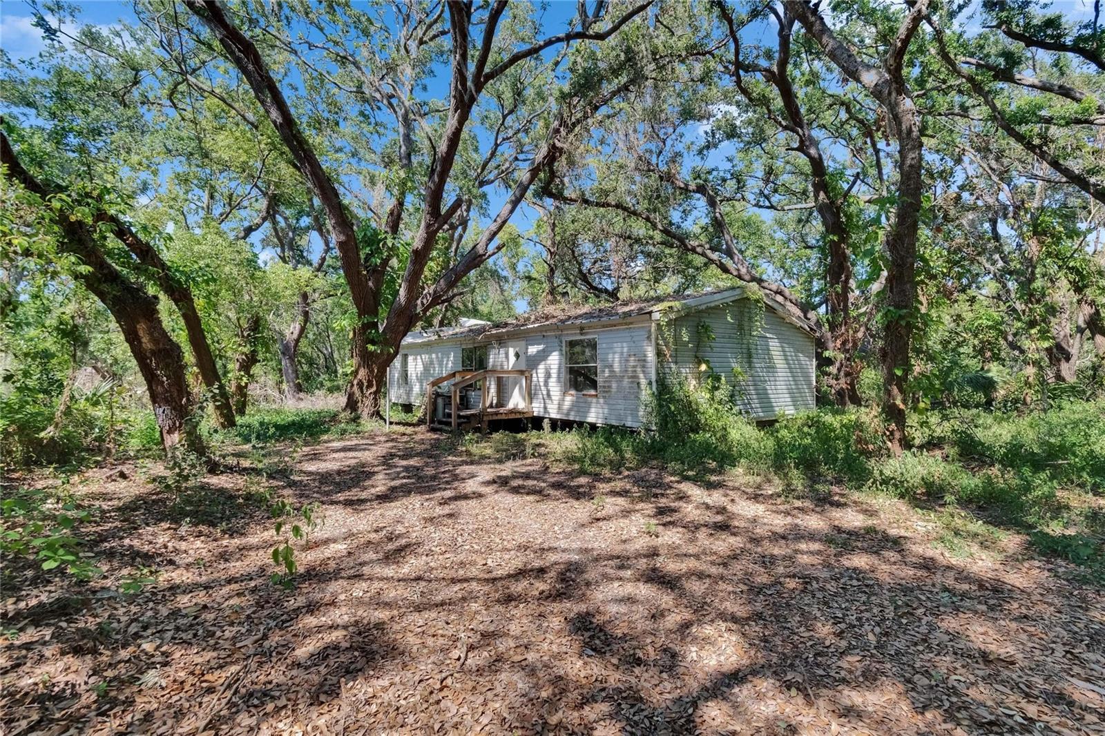 Doublewide that needs a lot of work, but could become a second home on the property