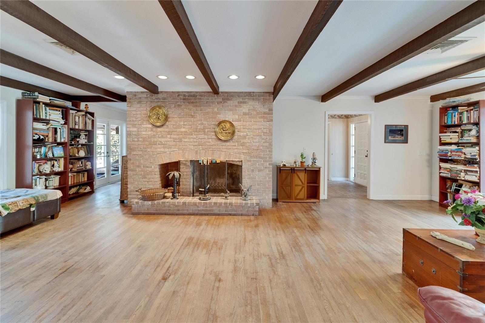 Grand Family Room with Brick, Wood-burning Fireplace & Wood Beams