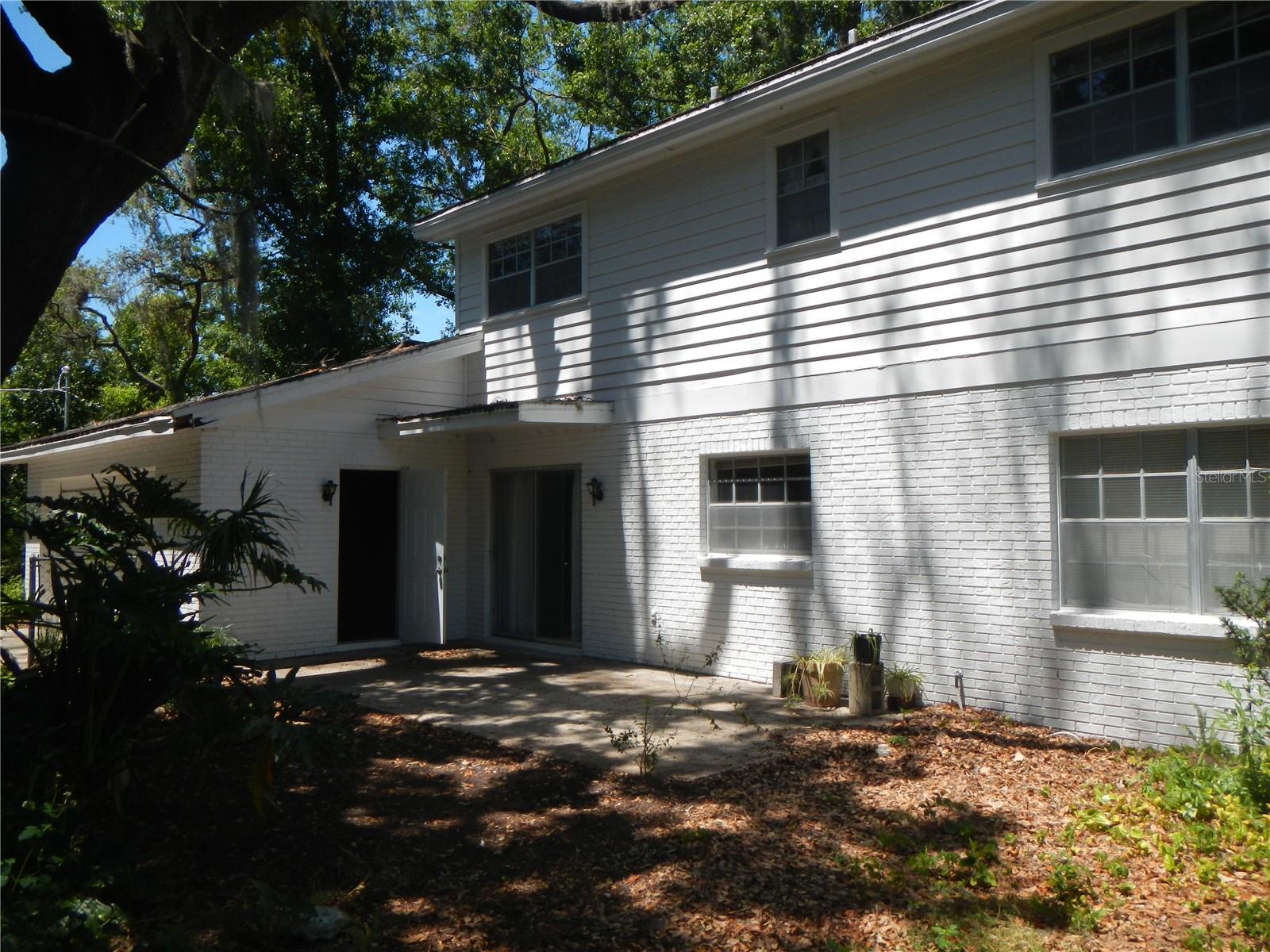 Back of house, door leading into garage and sliding glass doors to Dinette.