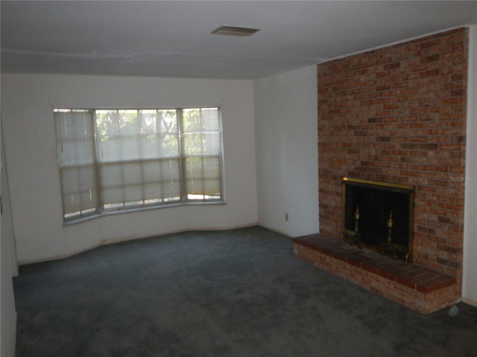 Formal Living Room Area with Fireplace.