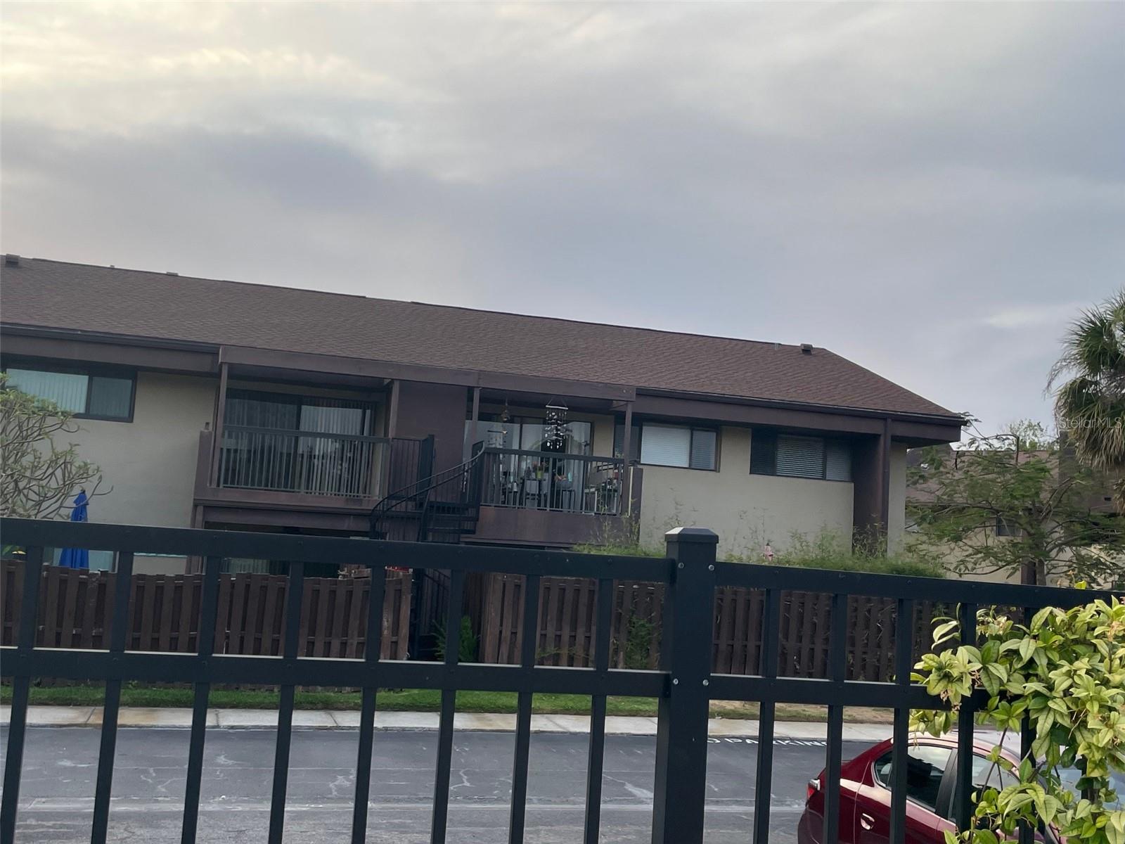 Rear view of end unit (201) looking from pool area.