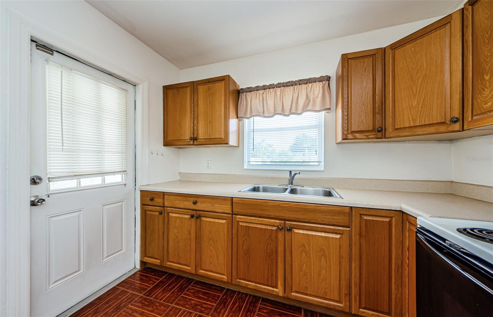 kitchen door leads to the outside laundry-storage