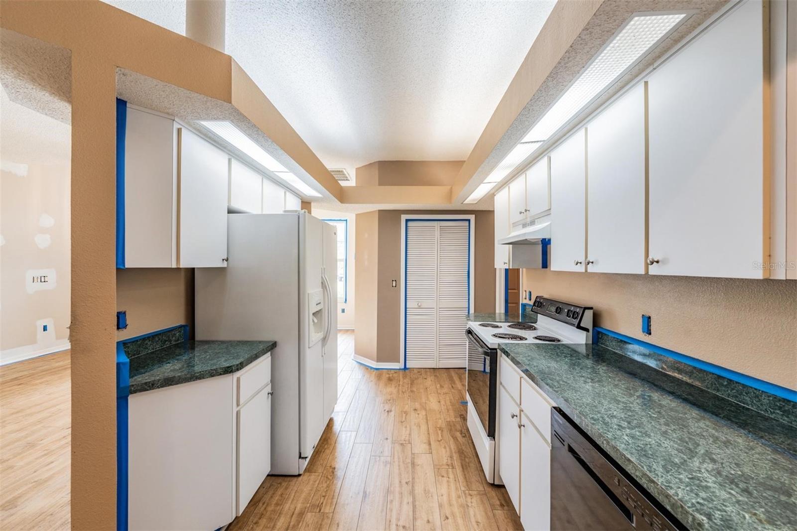 Owner is currently painting the interior.  Pantry straight ahead.  Laundry room to the right.  Living room to the left.  Family room to the front right.