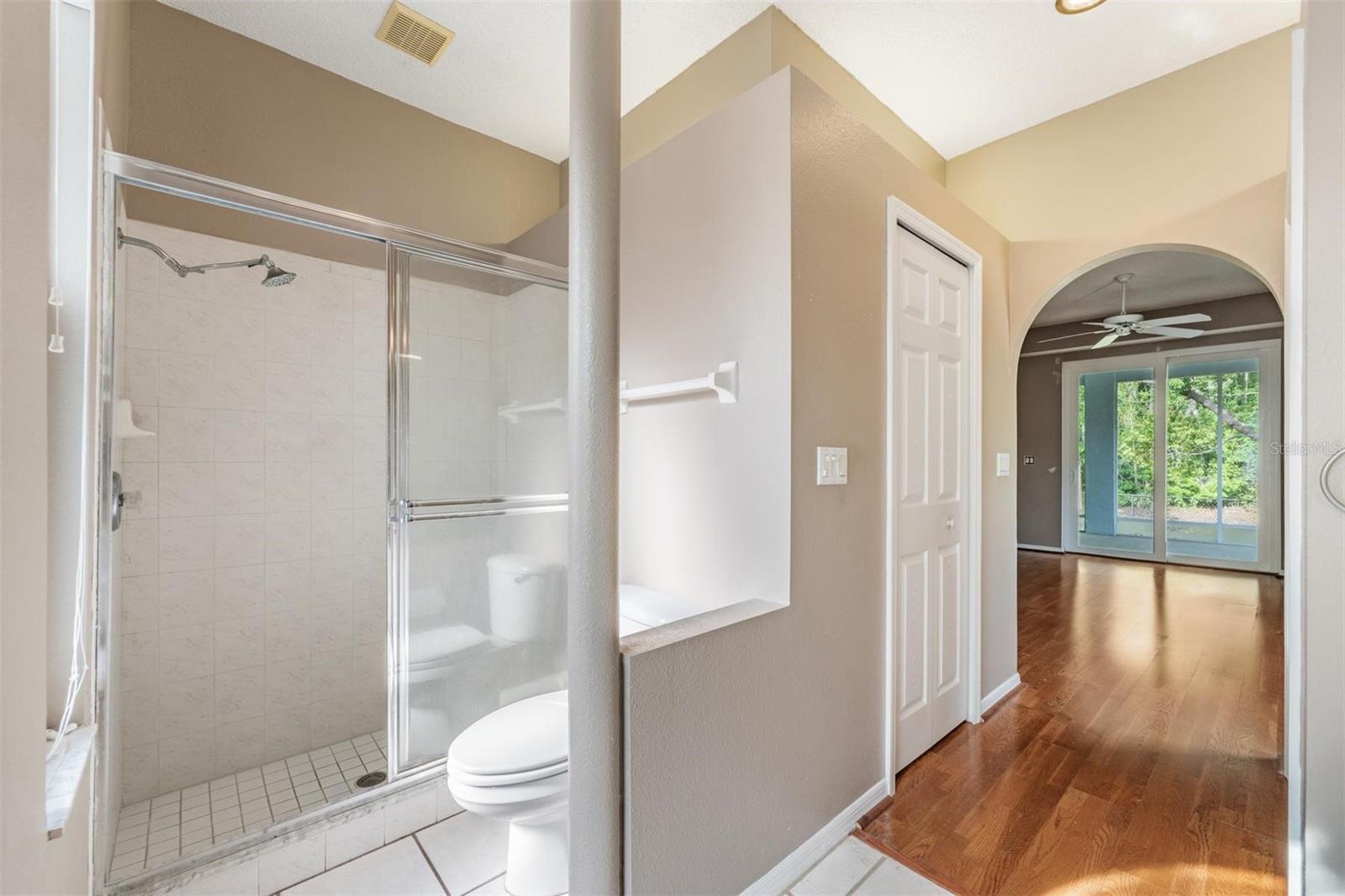 Bright Primary bathroom with can lights. His and Her closets.