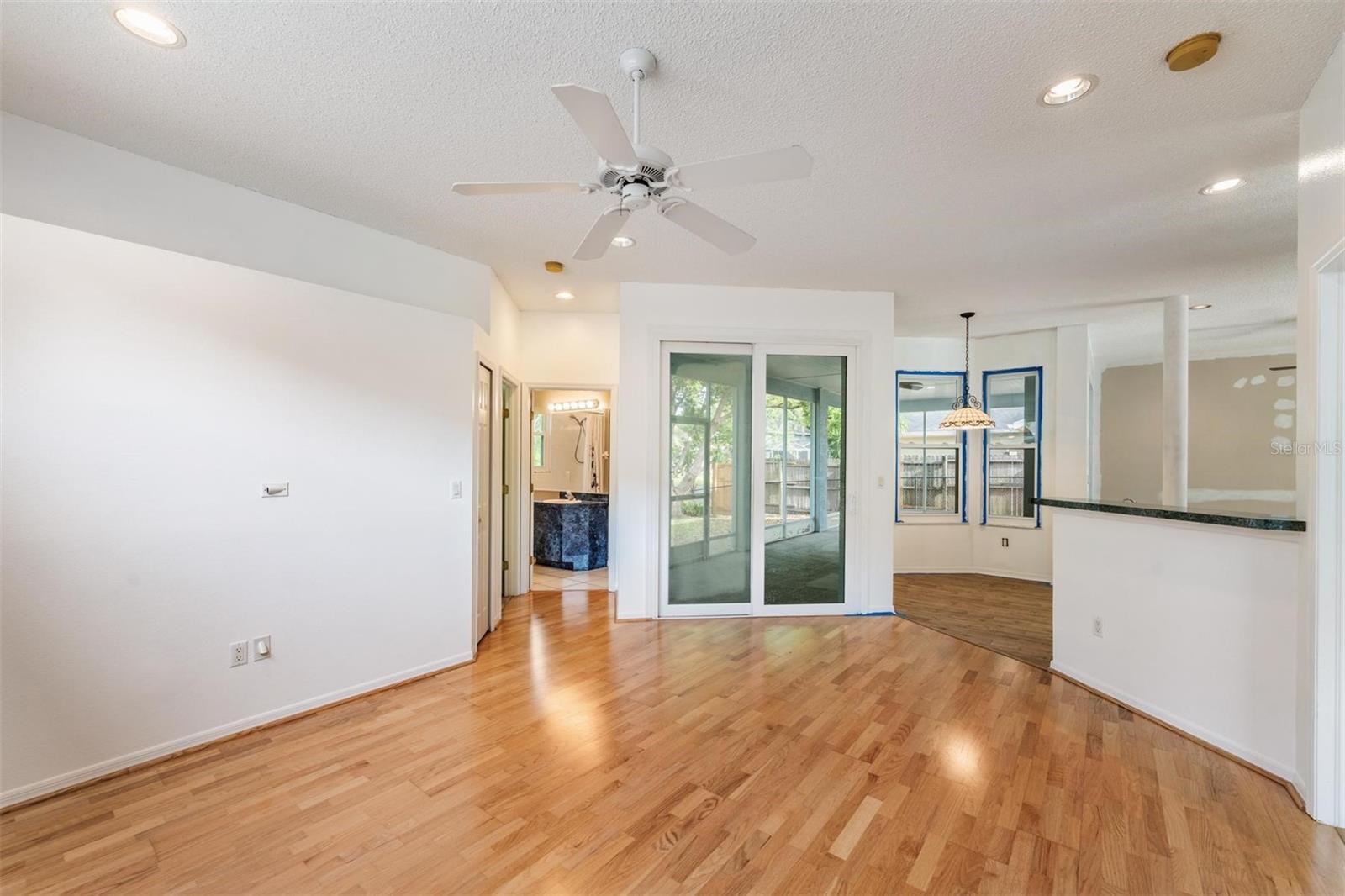 Family room. Kitchen is to the right and breakfast nook with having light.  To the left is the 2nd bedroom and community/lanai bathroom.  The 3rd bedroom is to the immediate right.