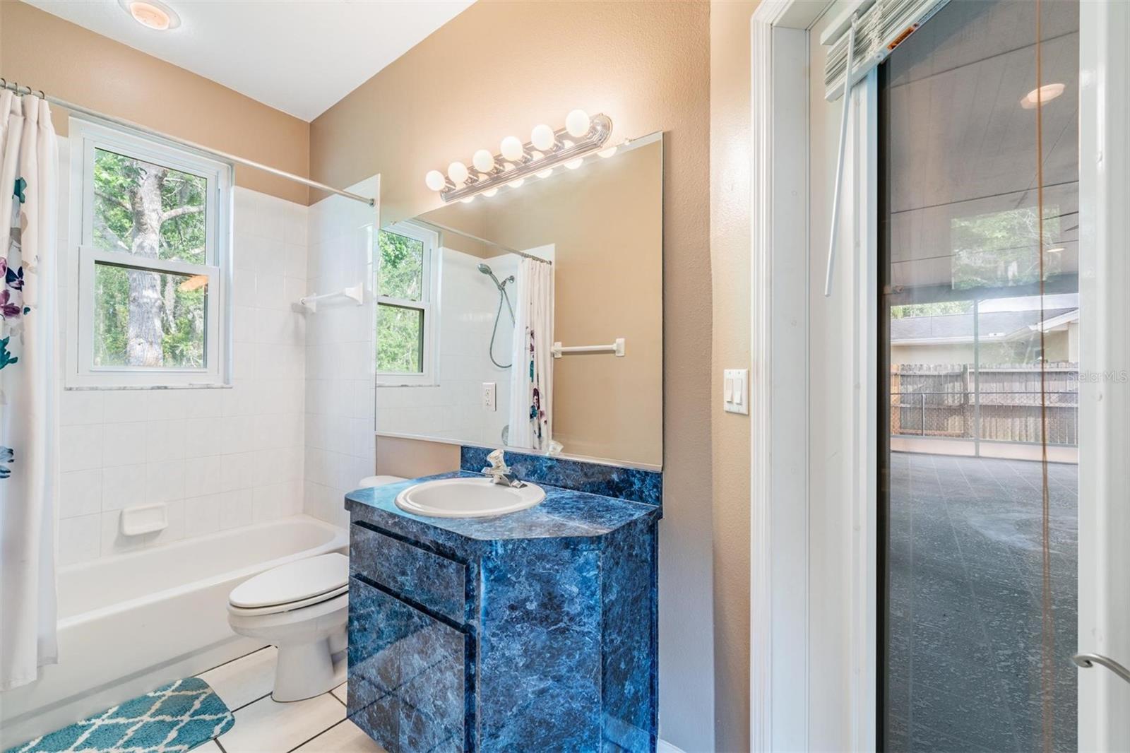 Community bathroom with door to lanai.