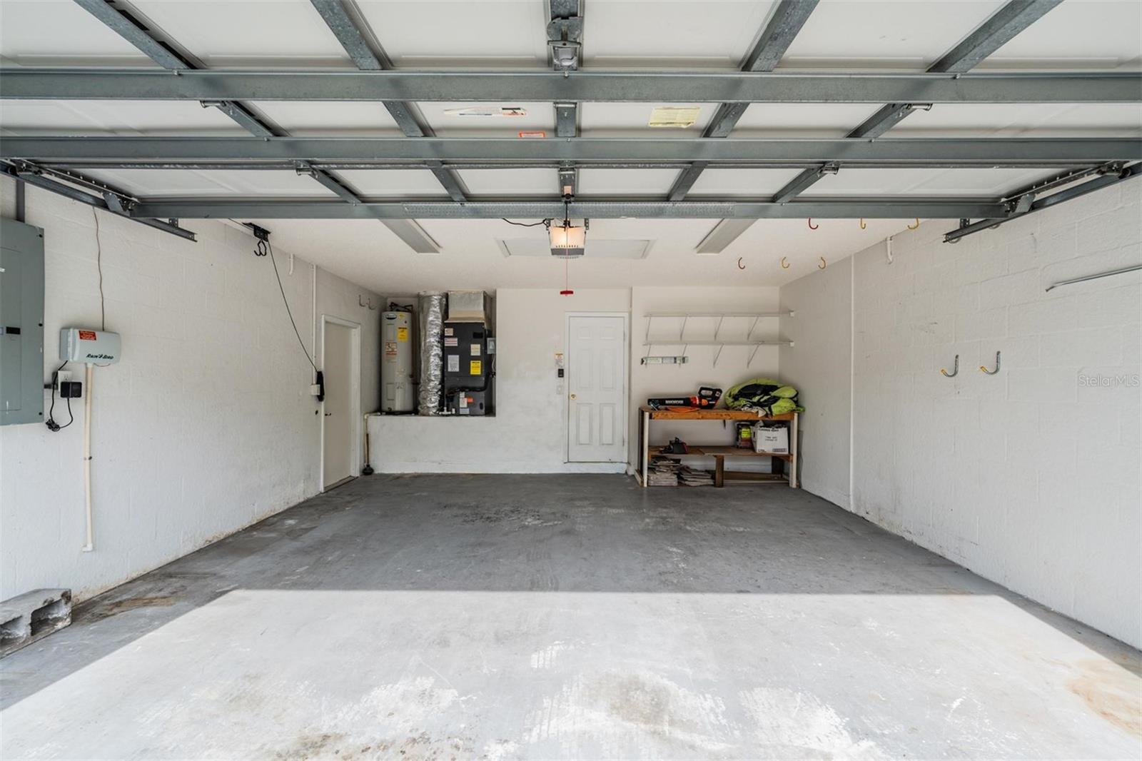 Large 2 car garage.  Work bench conveys.  In person you will see a red Camaro in the garage. This car belongs to a neighbor who is selling it. Please do not touch. Kayak hooks are to the left on the ceiling.