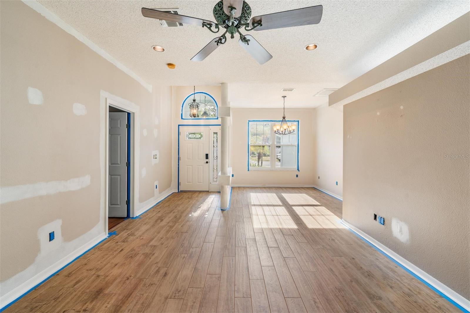 Owner is currently painting the interior. Front door with dining room to the right. New fan, can lights and Porcelain tile.