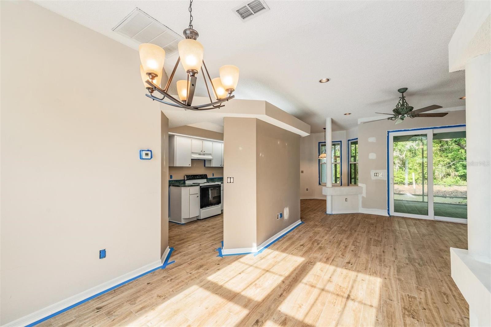 In Dining area. Porcelain tile.  Kitchen and laundry room to the left.
