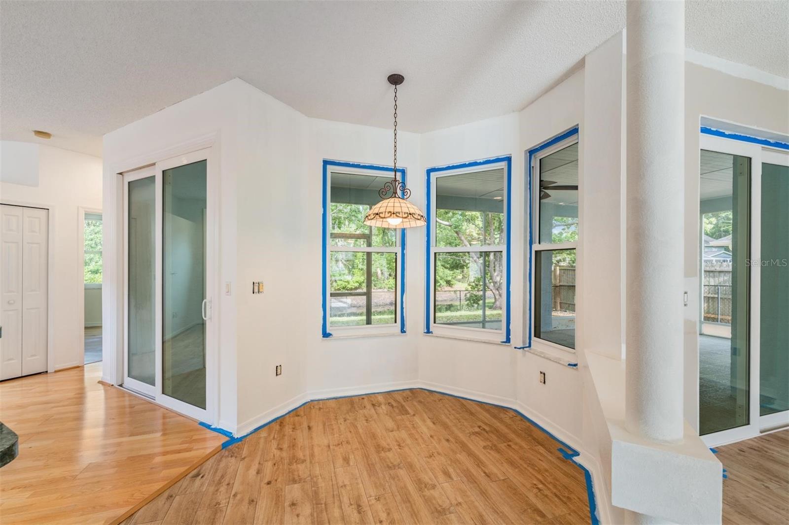 Owner is currently painting the interior. In Breakfast nook.  Two hurricane proof double pane slider doors to the screened lanai.  2nd bedroom to the Left next to the family room.