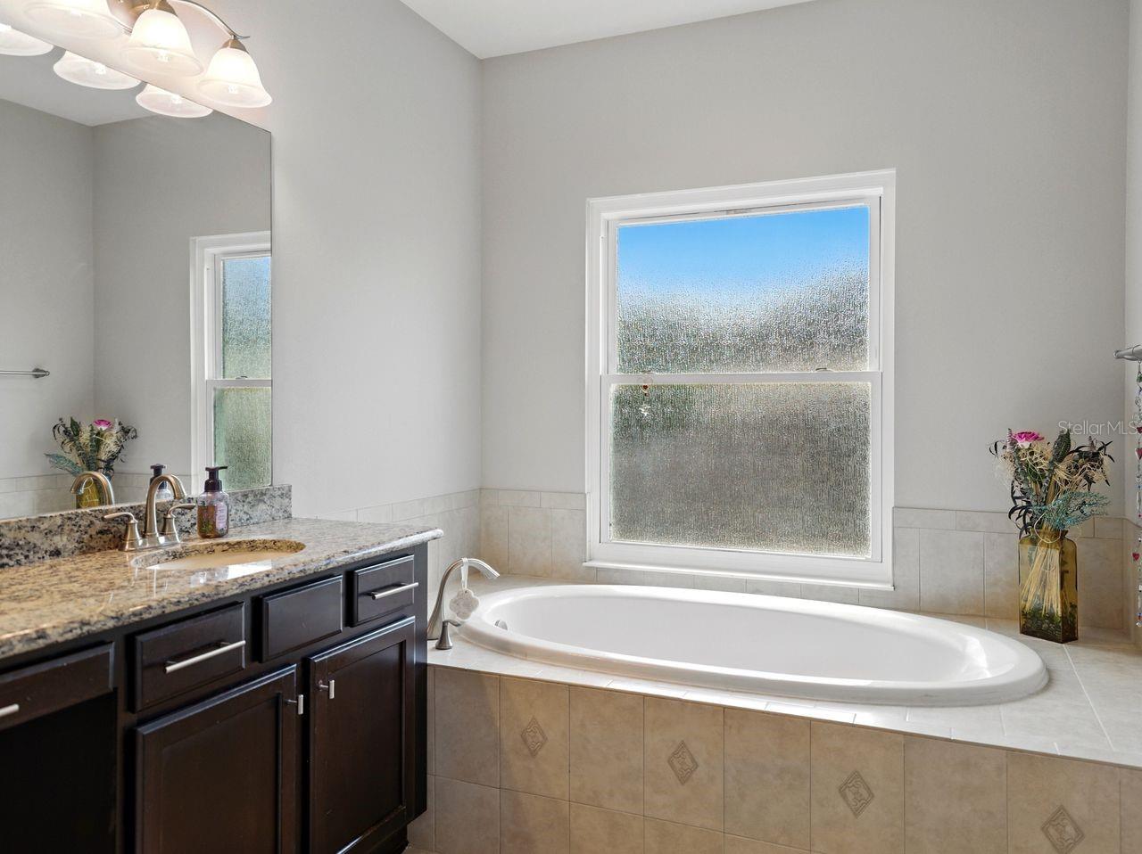 New obscured privacy glass window installed in the primary bathroom.