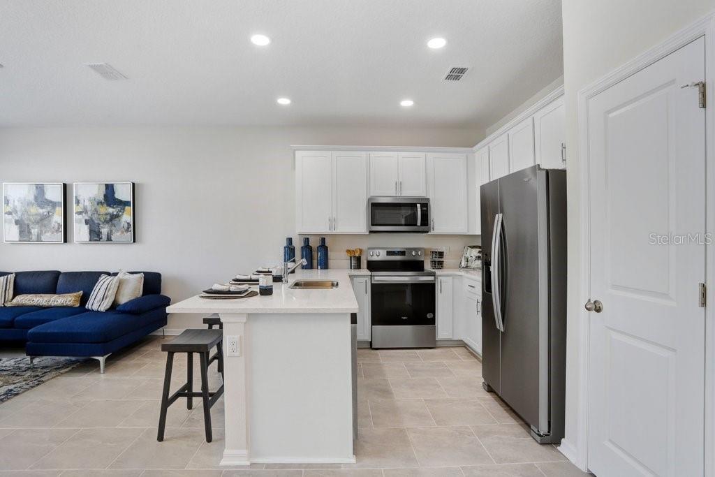 Kitchen includes Range, Microwave, Dishwasher, Disposal (photo of staged model)