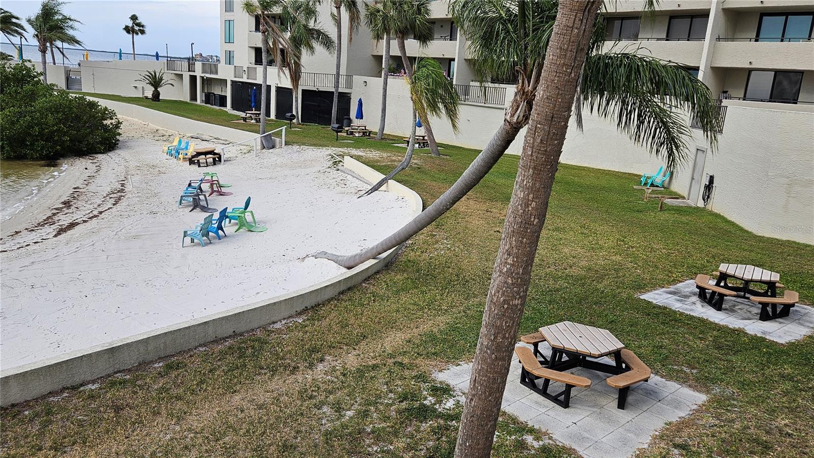 beach area with picnic tables and grills