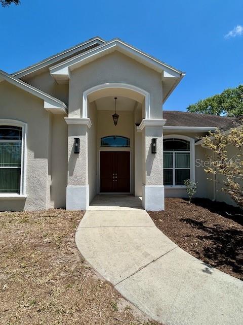 Front Walk-up Entry with Cathedral Lighting and Coach Lights