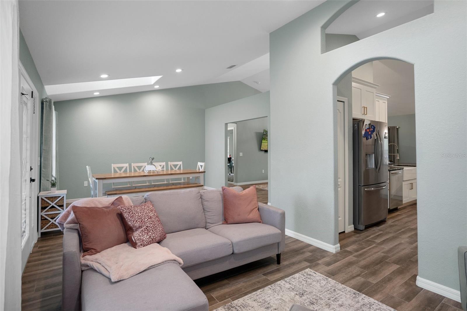 There is an arched doorway from the formal living room into the kitchen