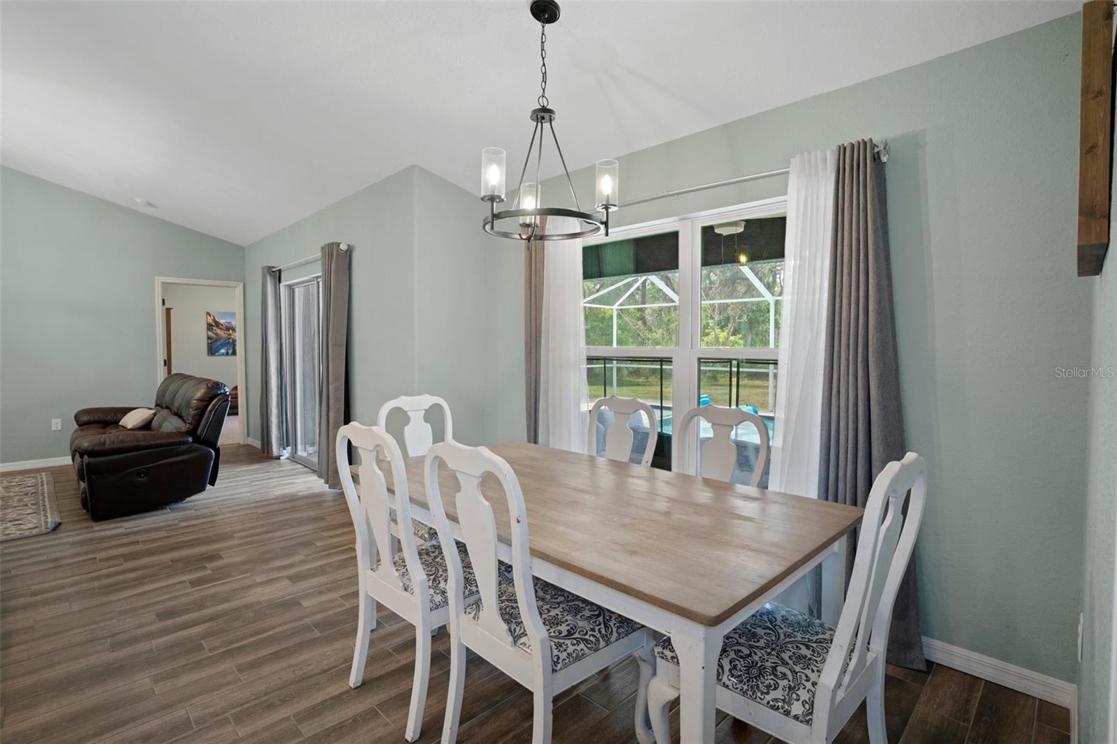 This spacious breakfast nook overlooks the gorgeous salt water pool