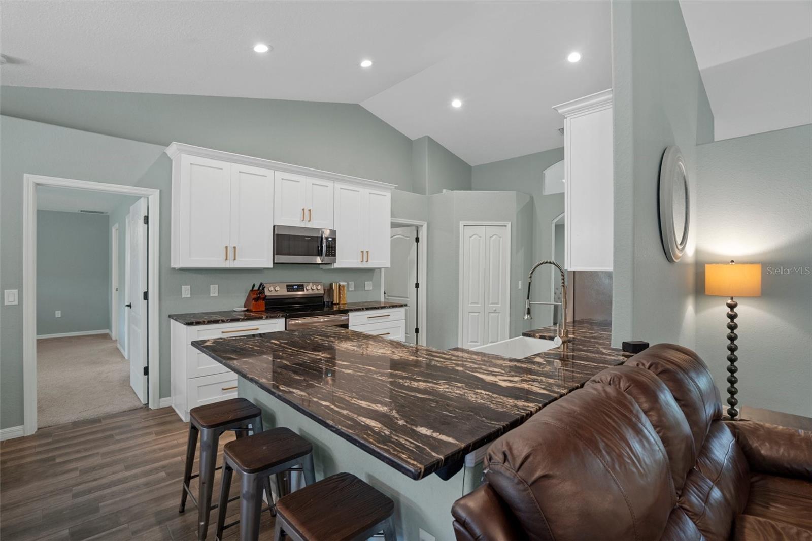 Notice the gorgeous granite breakfast bar